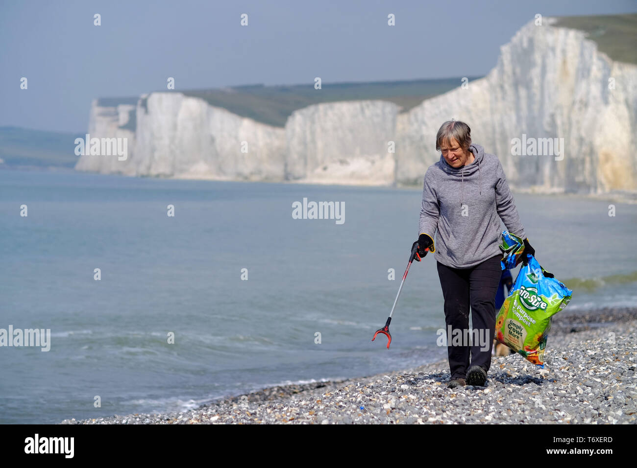 Birling Gap, East Sussex, UK. 3rd May 2019. Volunteers fdor the National Trust scour the beach  for plastic rubbish below the iconic white cliffs of the Seven Sisters. © Peter Cripps/Alamy Live News Stock Photo