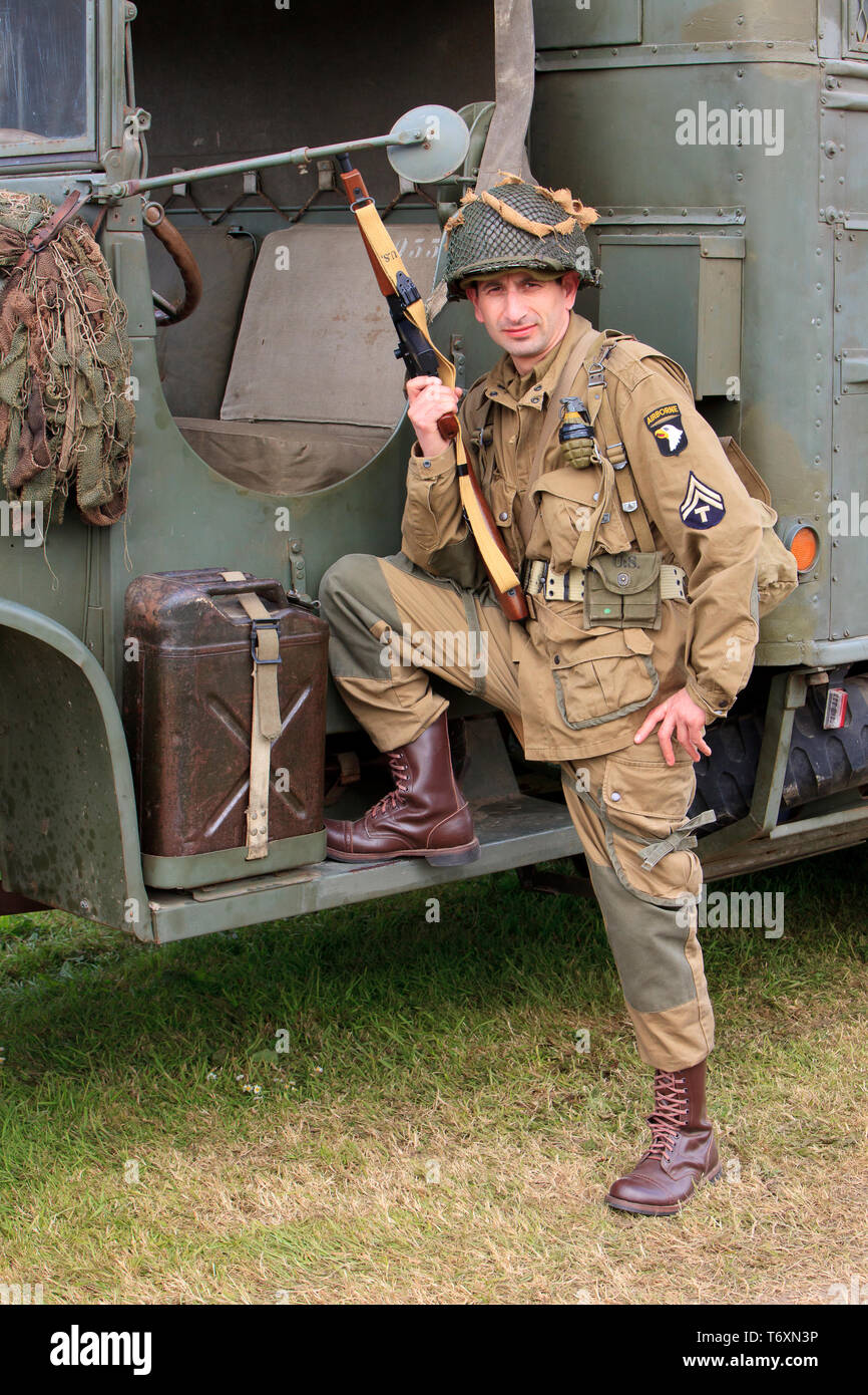 A Technician 5th Grade of the 101st Airborne Division of the US Army with a Thompson M1A1 submachine gun at the D-Day celebrations in Normandy, France Stock Photo