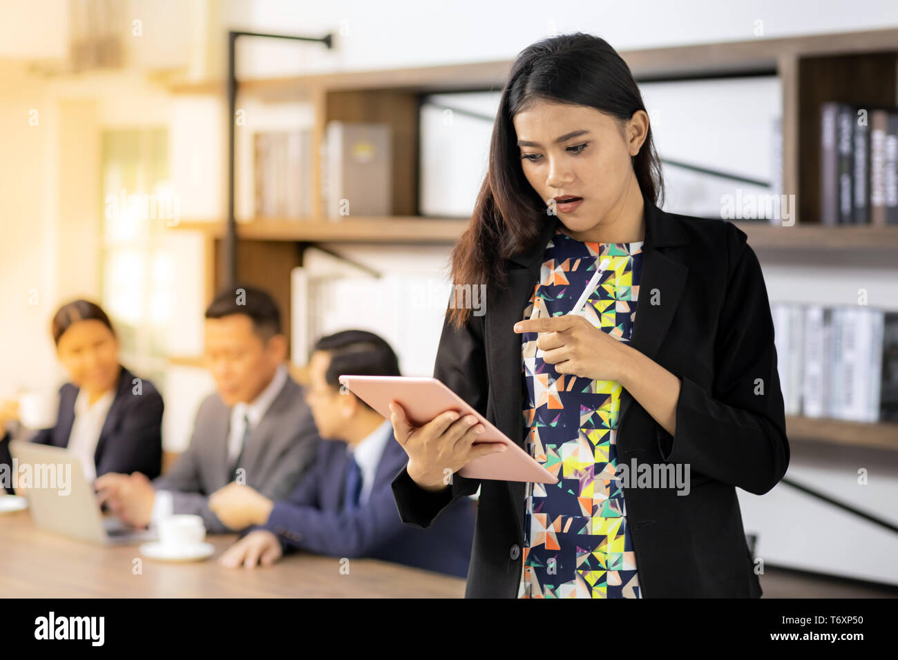 asian Businesswoman working with smart tablet Stock Photo
