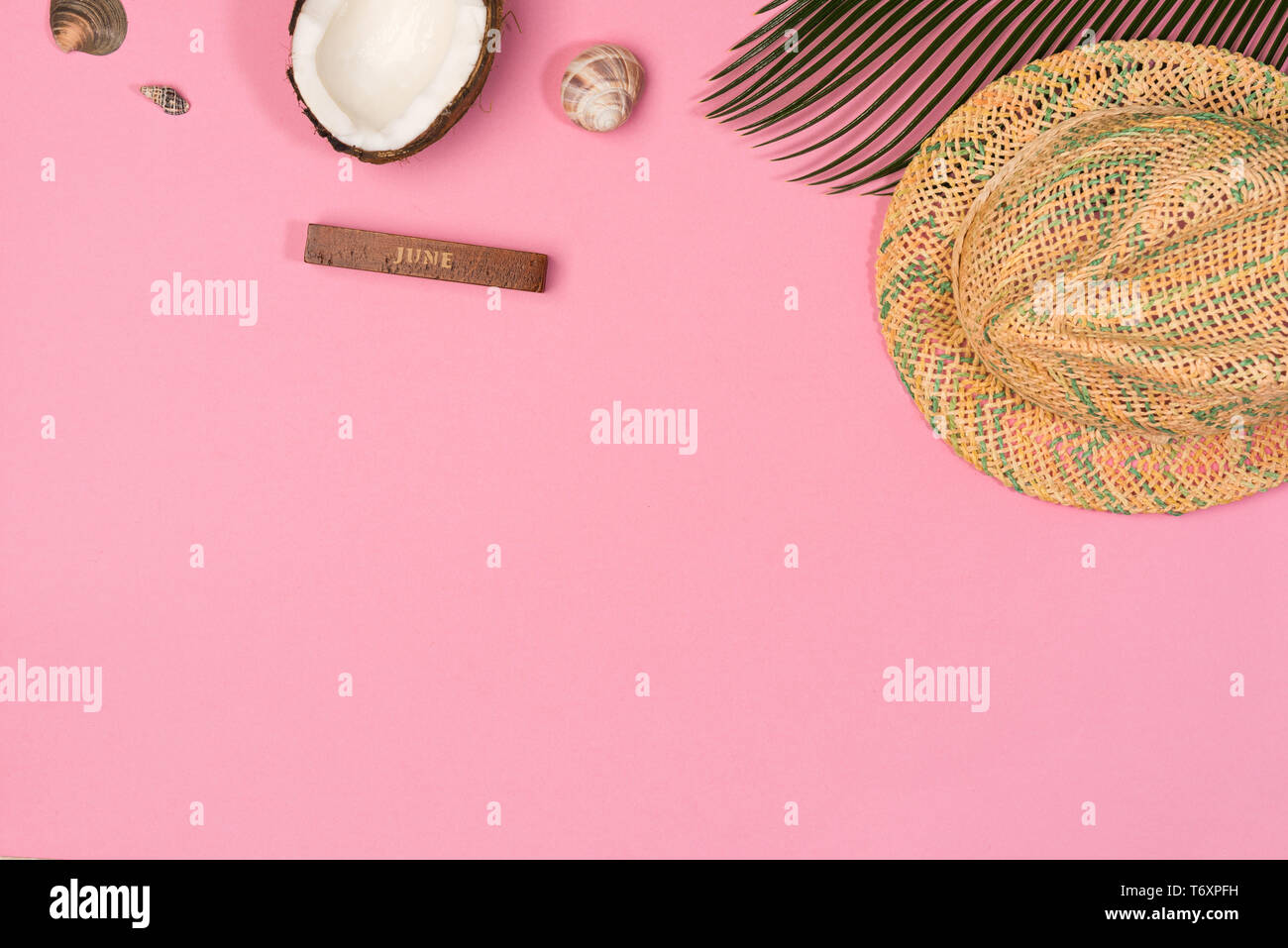 coconut, palm leaf, hat,  on a pink background, top view Stock Photo