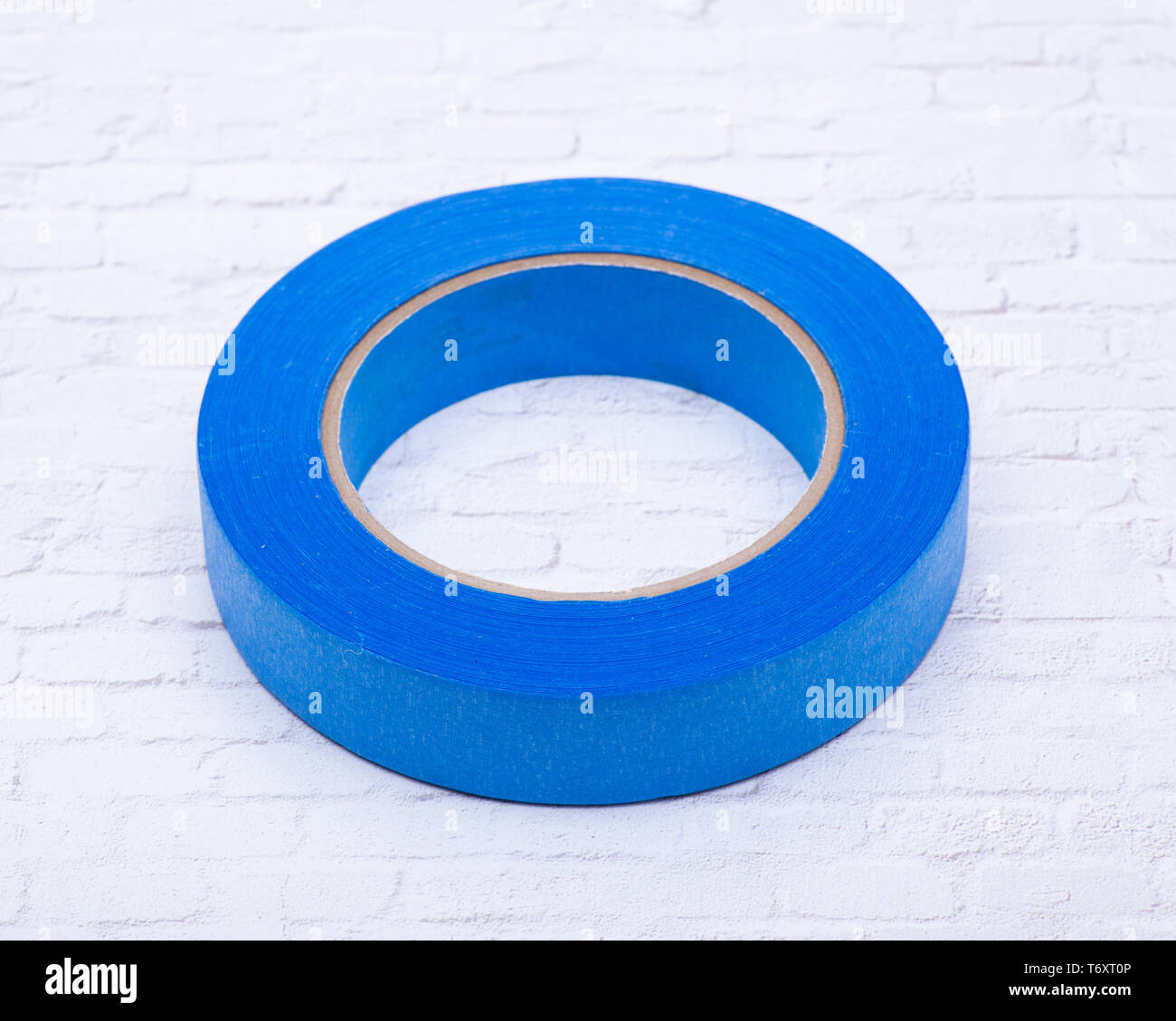 Blue Painter's Tape for multi surfaces isolated on white brick wall