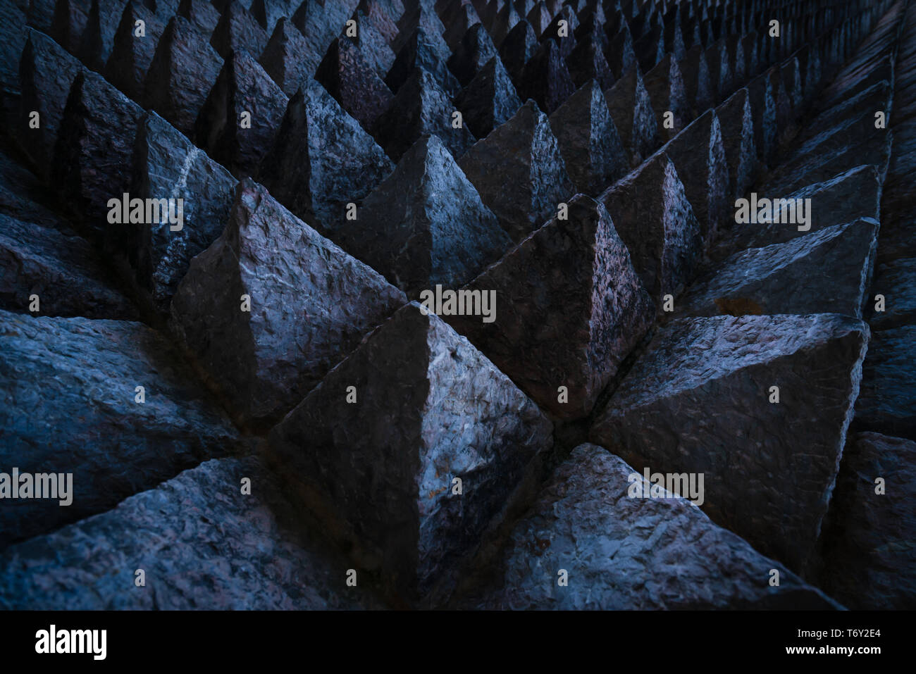 Sharp tip concrete architecture texture background. Art picture of unique pattern of dark stone carving in pointed triangle shape. Concept of obstacle Stock Photo