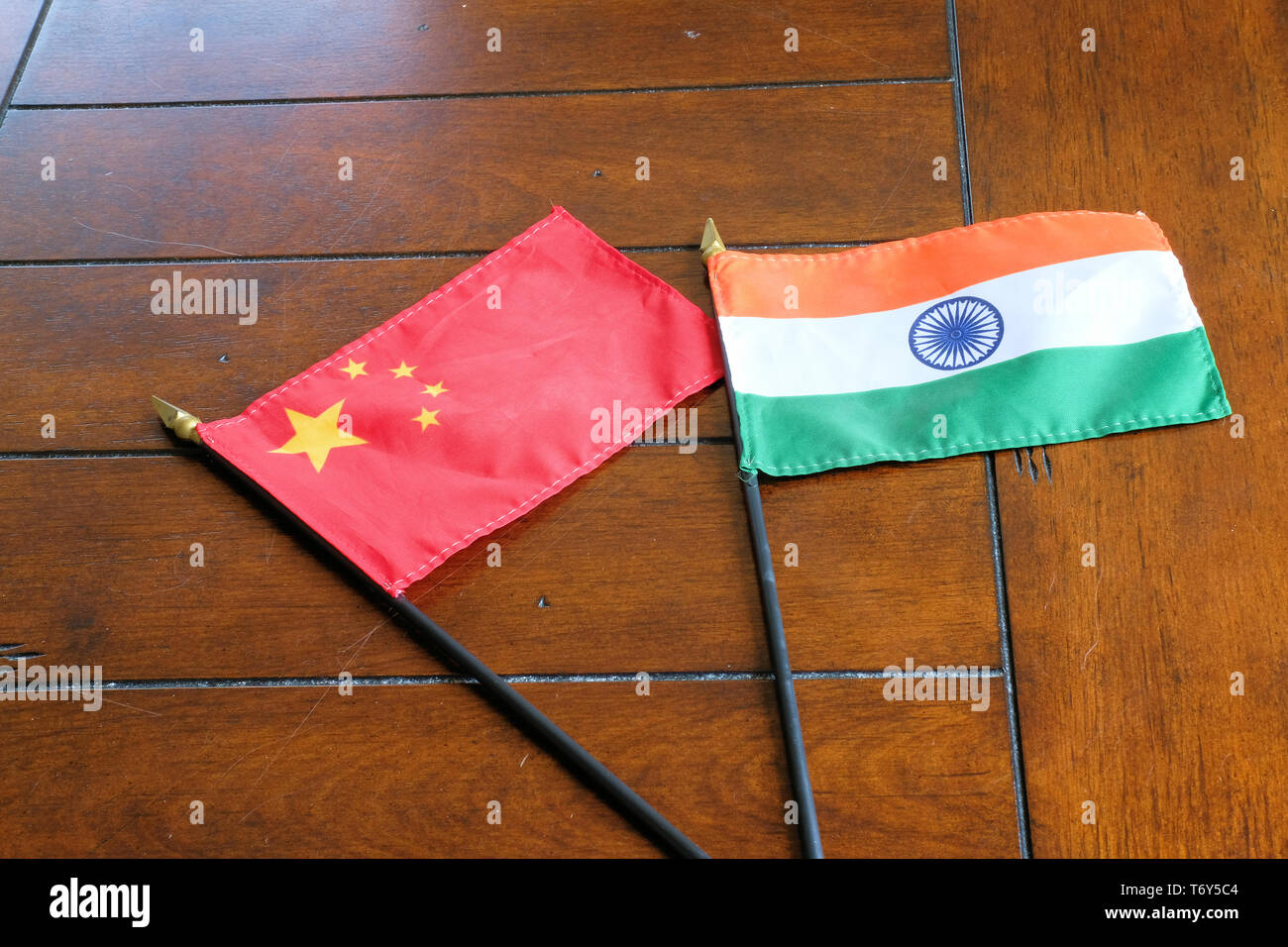 Flags of China and India on a wooden surface; Chinese-Indian relations. Stock Photo