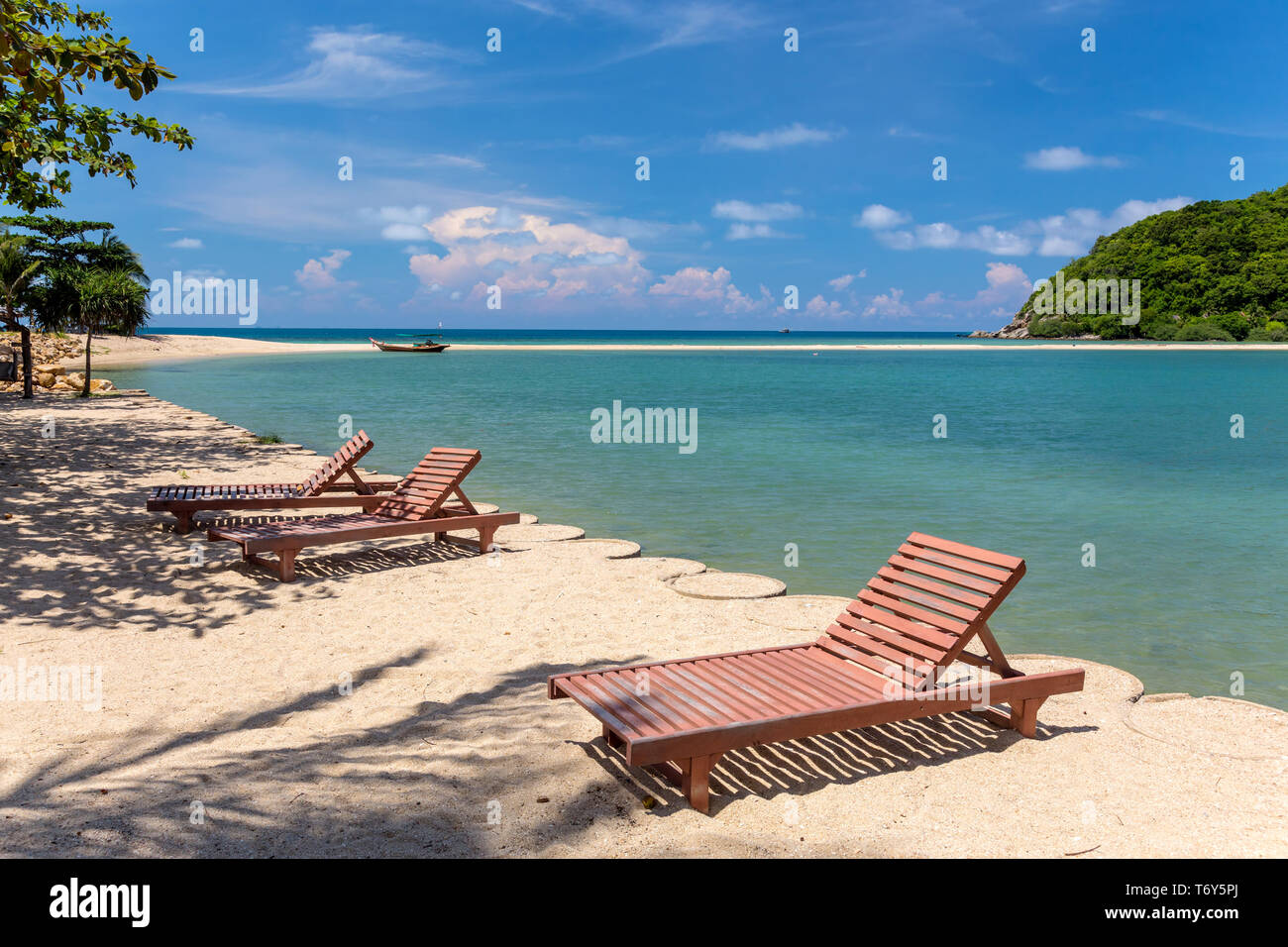 Sunbeds on a tropical beach, Thailand Stock Photo