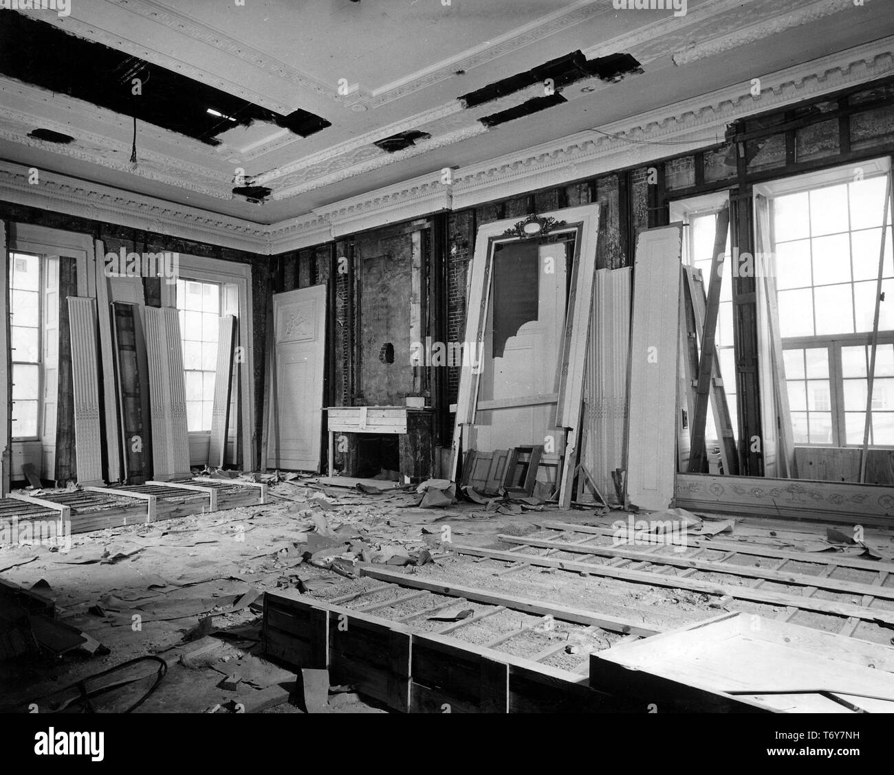 Angled view of the East Room, filled with loose paneling, framing, and building debris, during President Truman's White House Reconstruction, Washington, District of Columbia, January 19, 1950. Image courtesy National Archives. () Stock Photo
