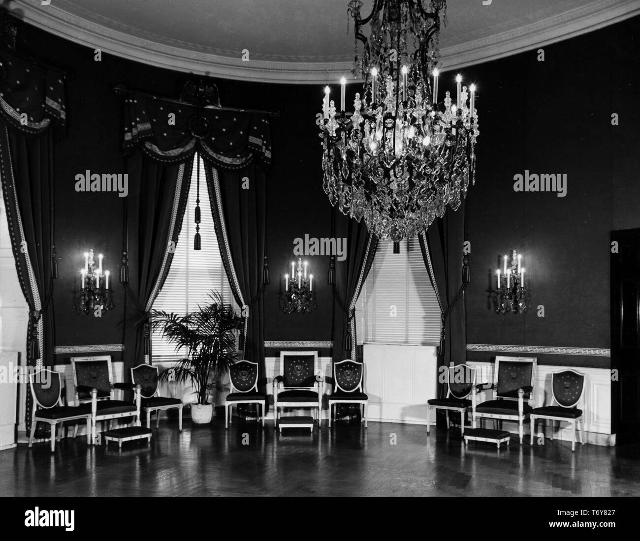 The White House Blue Room, with candle sconces, a crystal chandelier and chairs lining the apse, Washington, District of Columbia, November 13, 1947. Image courtesy National Archives. () Stock Photo