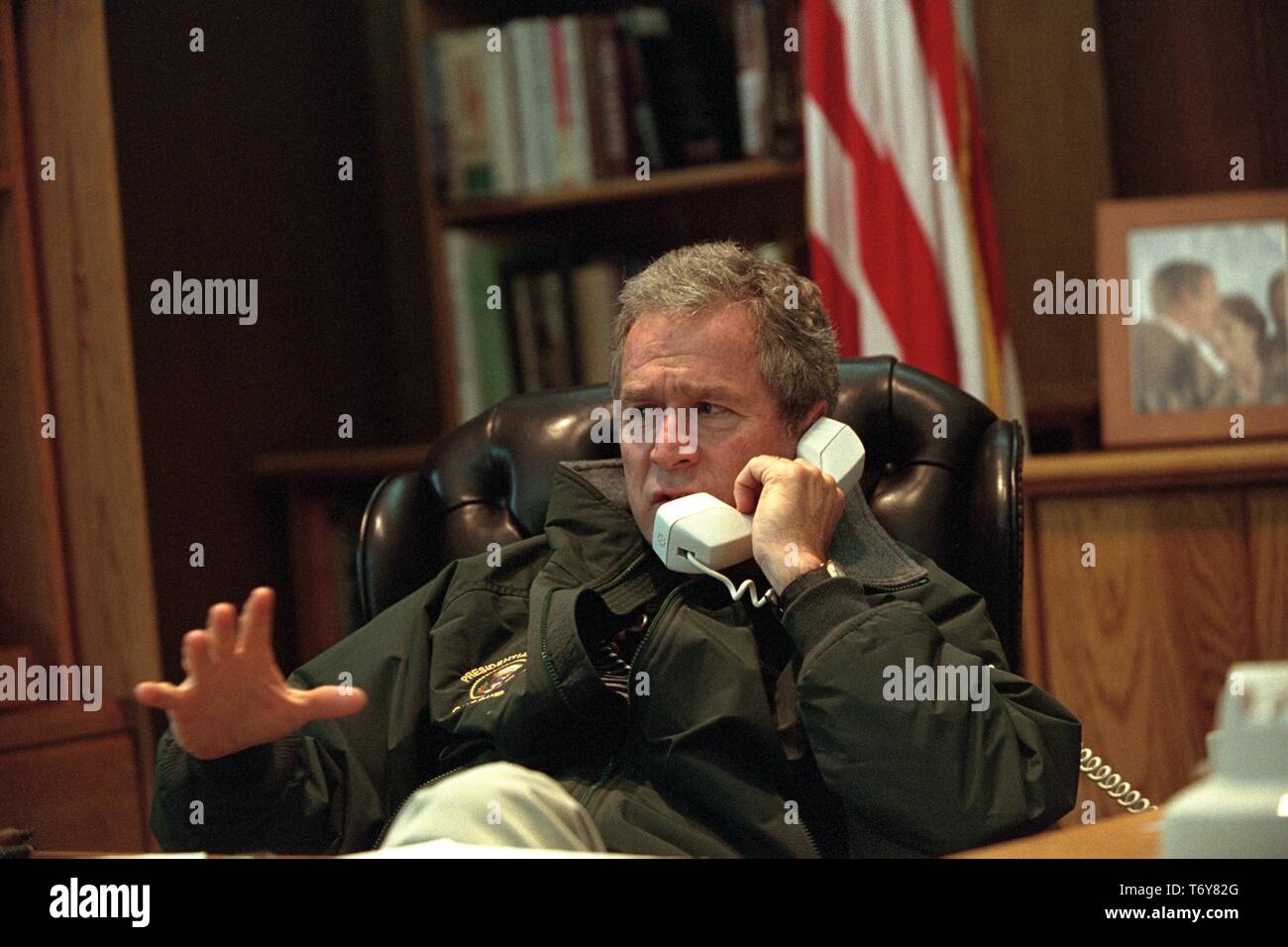 United States President George W Bush speaks with President of Russia Vladimir Putin on the telephone from his office at Camp David in Thurmont, Maryland, September 22, 2001. Courtesy National Archives. () Stock Photo