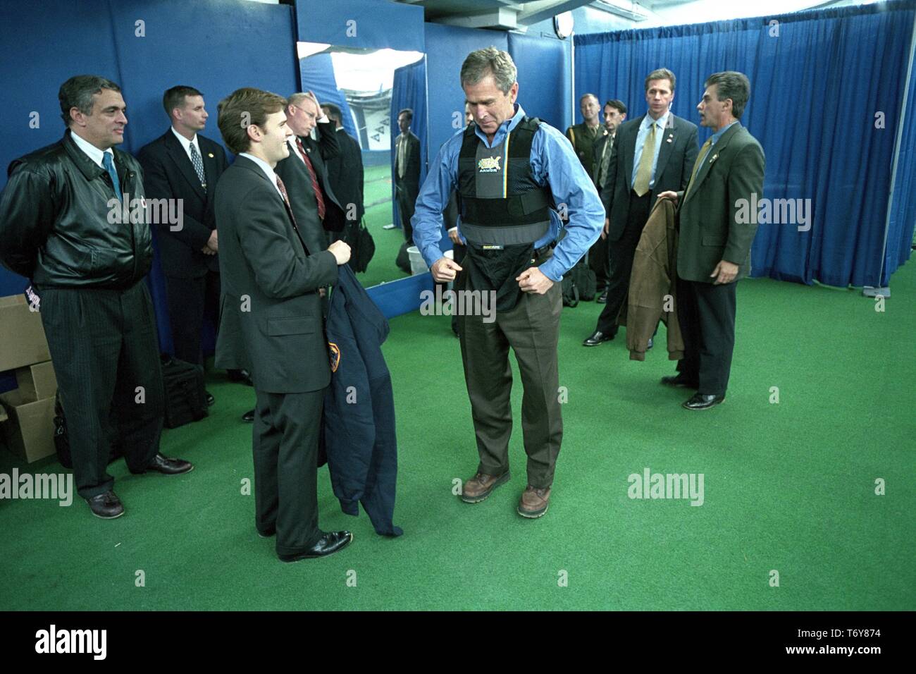 President George W Bush puts on a protective vest prior to throwing out the ceremonial first pitch in Game Three of the World Series between the Arizona Diamondbacks and the New York Yankees, Yankee Stadium in New York City, October 30, 2001. Courtesy National Archives. () Stock Photo