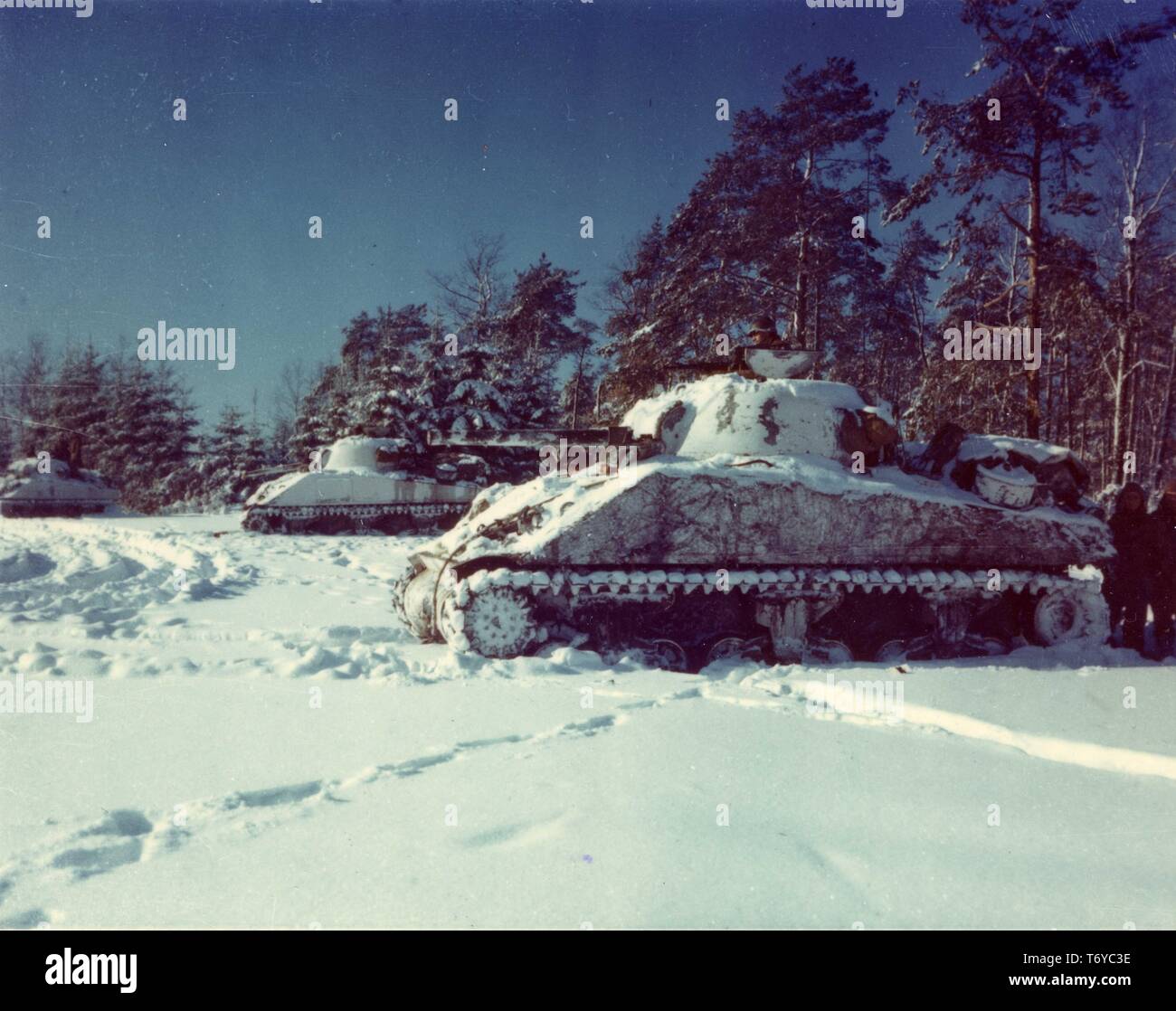 M-4 Sherman tanks of the 10th Tank Battalion lined up on a snow-covered field, during the Battle of the Bulge in World War II, near St Vith, Belgium, 1945. Image courtesy National Archives. () Stock Photo
