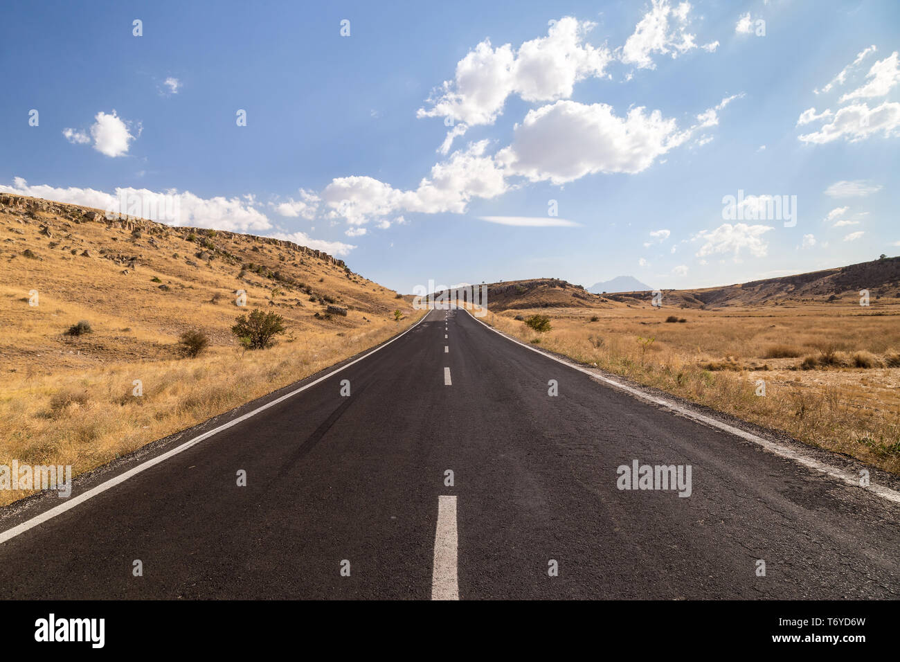 Long straight road going across countryside Stock Photo