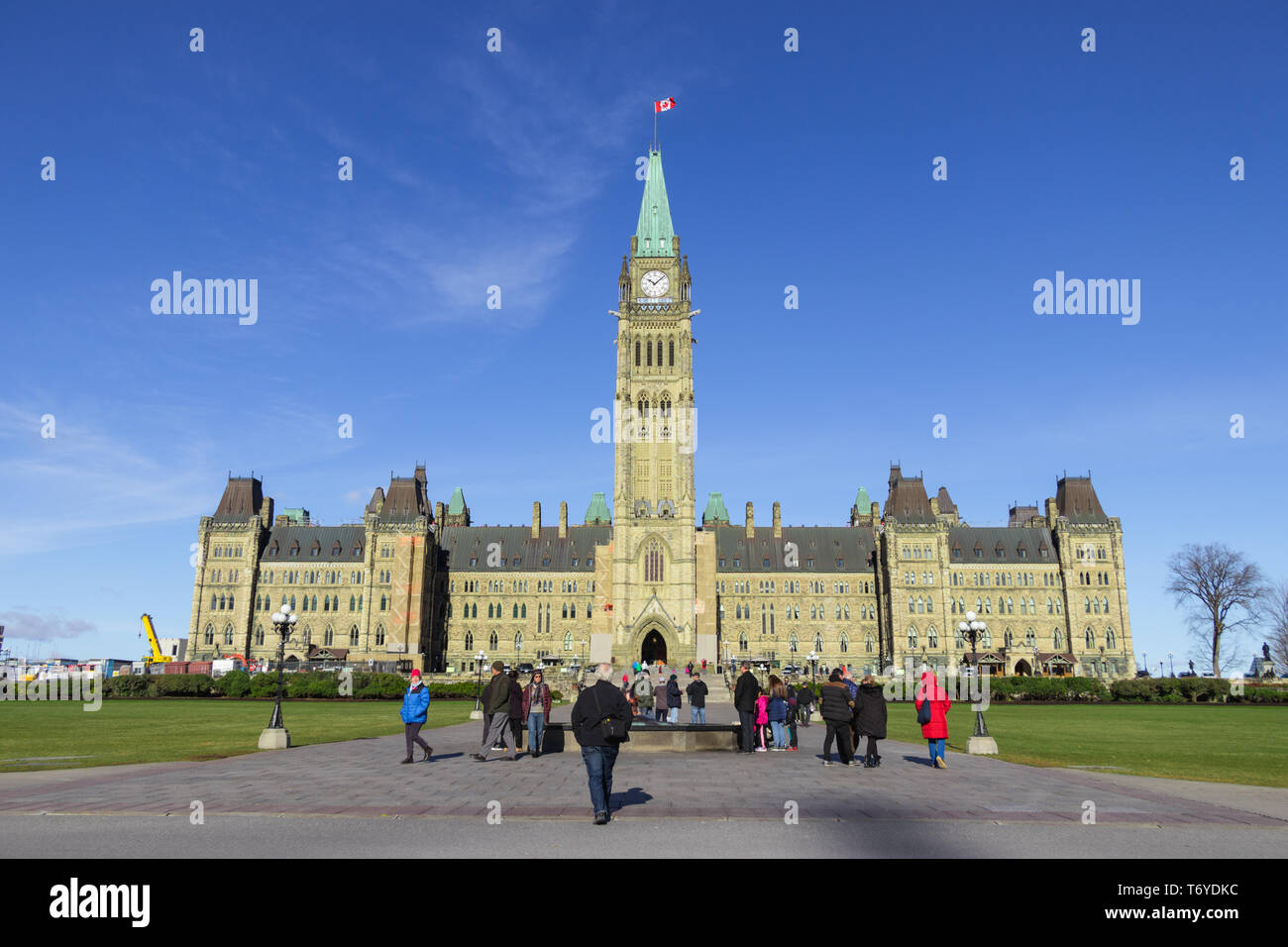 Ottawa, Ontario, Canada - November 2018 - Canadian Parliament, front view in Summer in a sunny day with Blue sky. People in the front of the building. Stock Photo