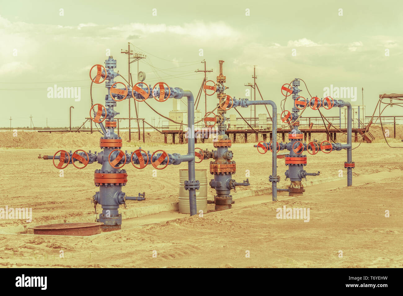 Wellheads with valve armature on a oil field Stock Photo Alamy
