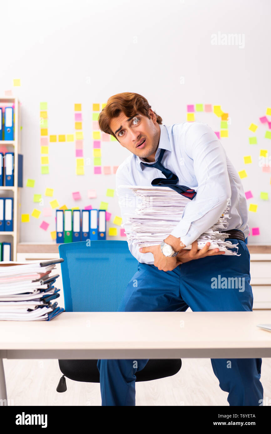 Young employee suffering from excessive work Stock Photo