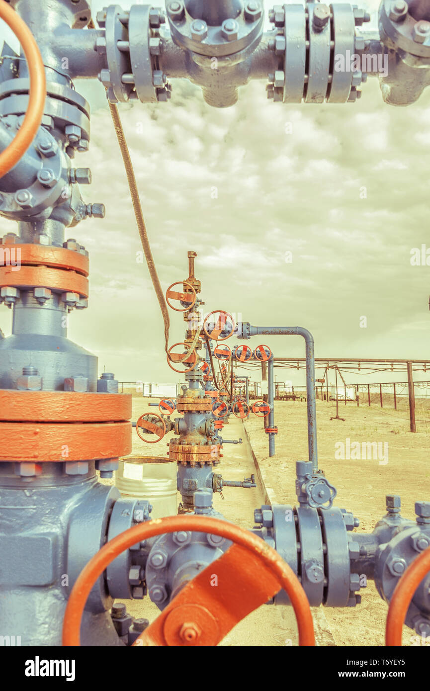 Wellheads with valve armature on a oil field Stock Photo Alamy