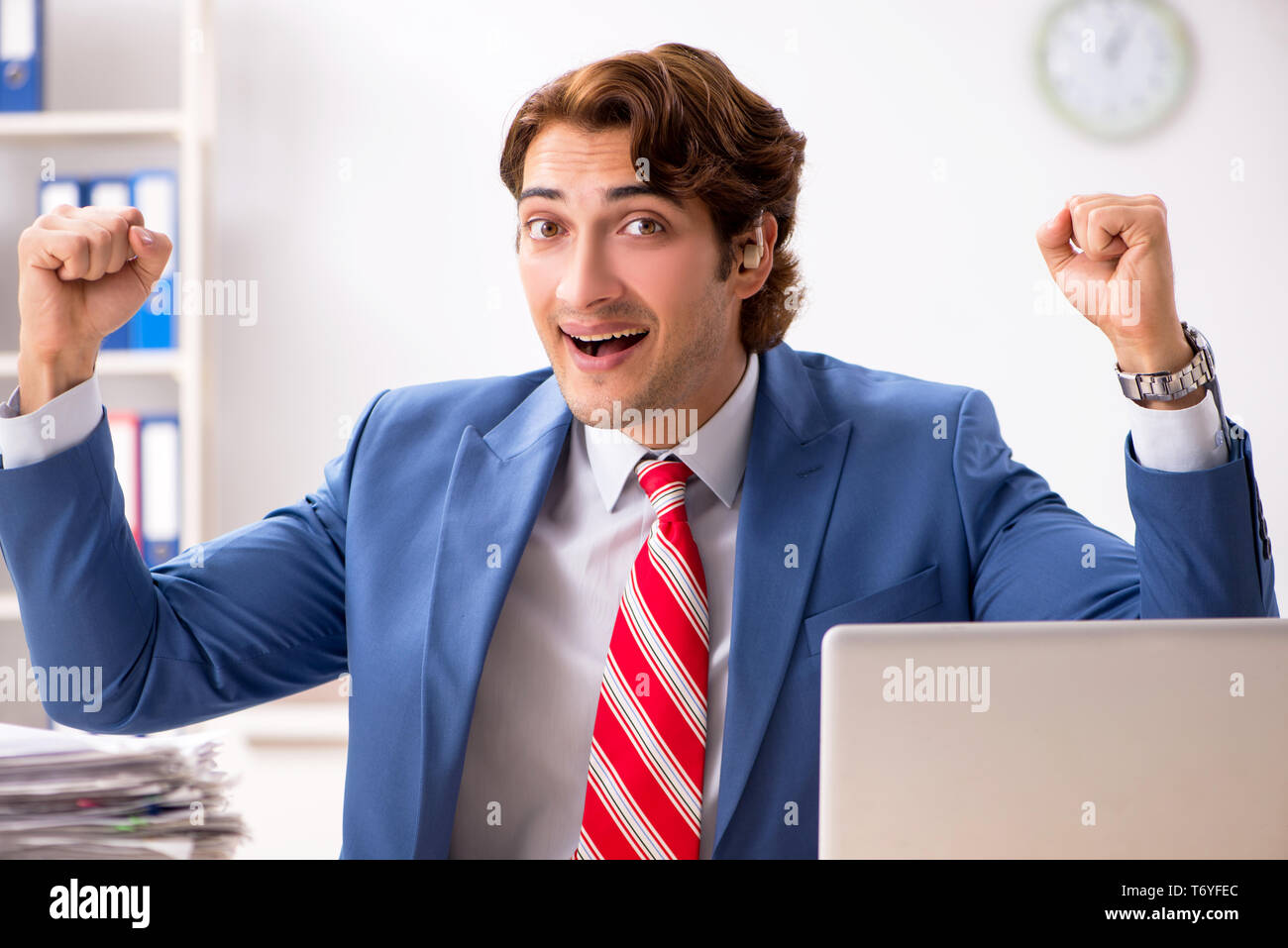 Deaf employee using hearing aid in office Stock Photo Alamy