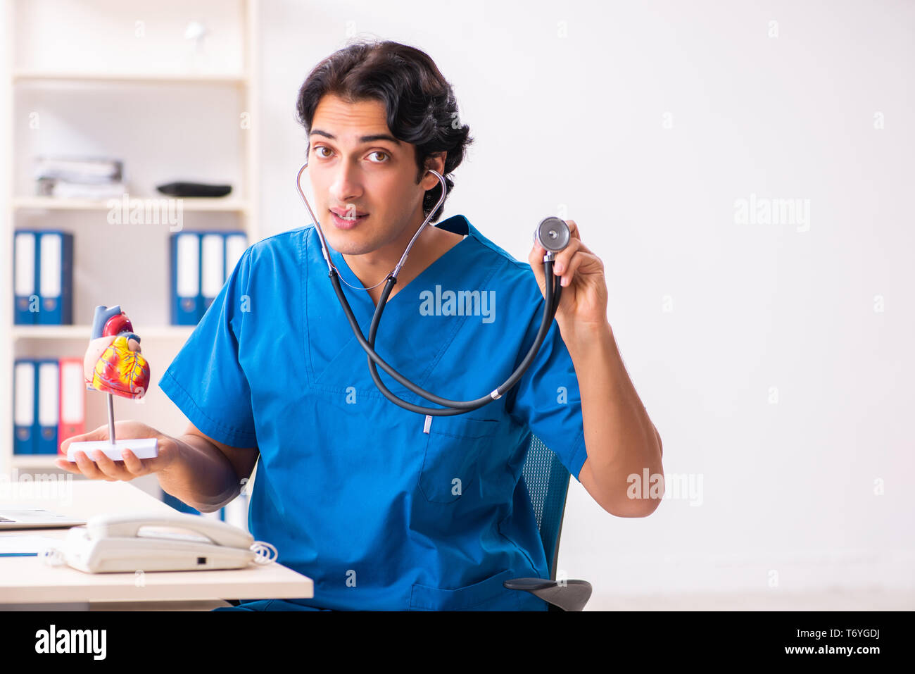 Handsome doctor listening young hi-res stock photography and images - Alamy