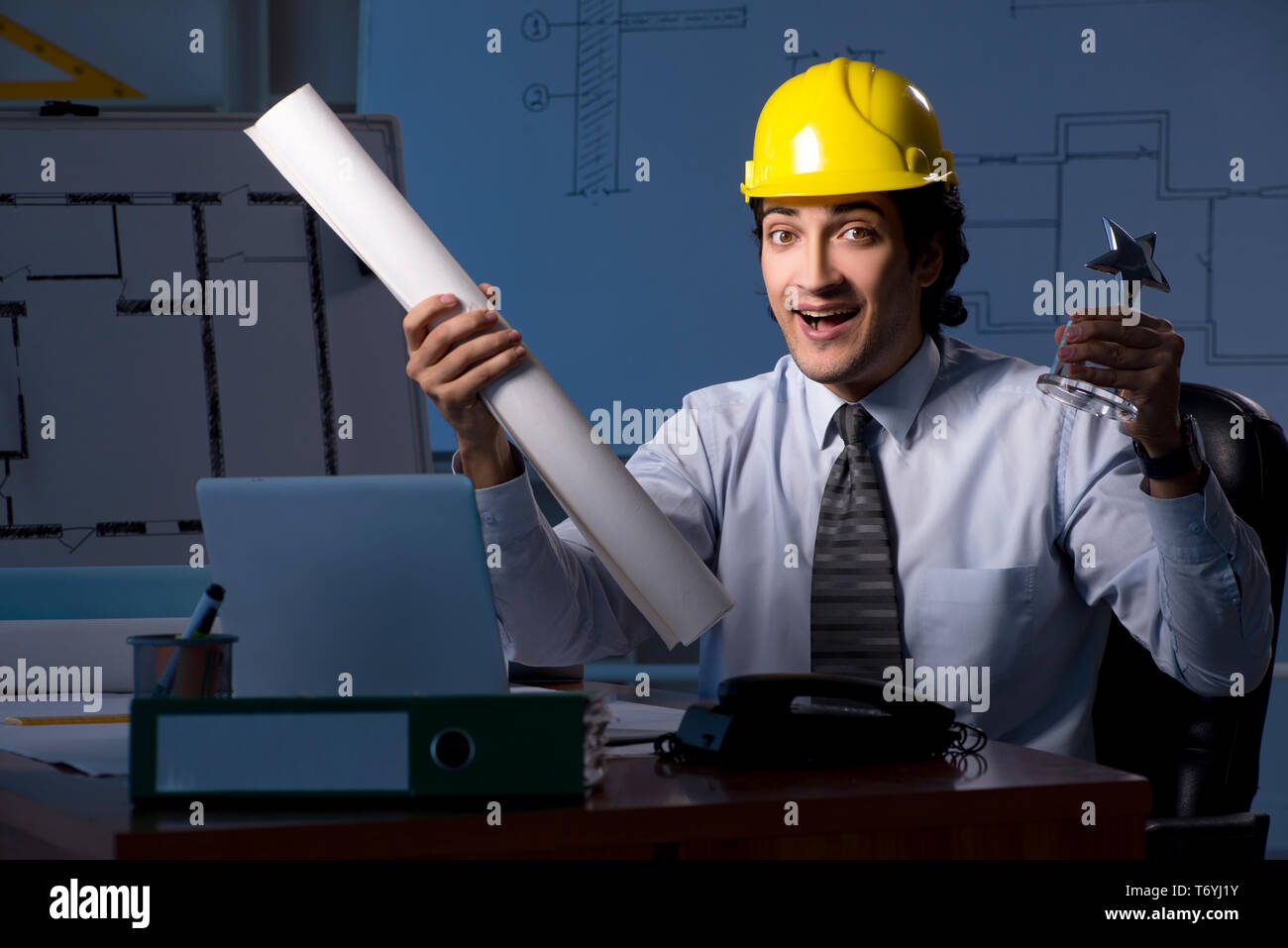Young construction architect working on project at night Stock Photo