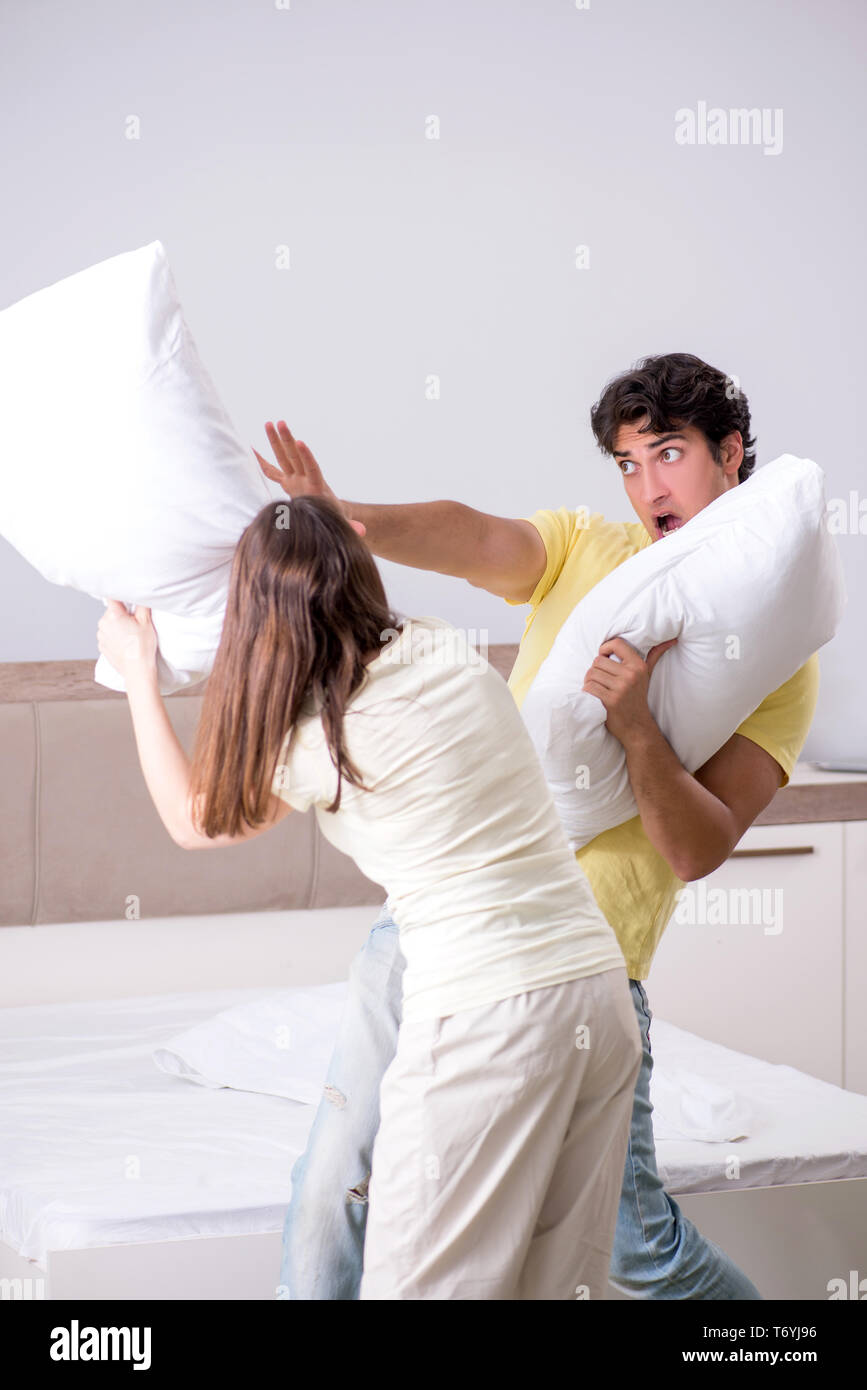 Wife and husband having pillow fight in bedroom Stock Photo Alamy