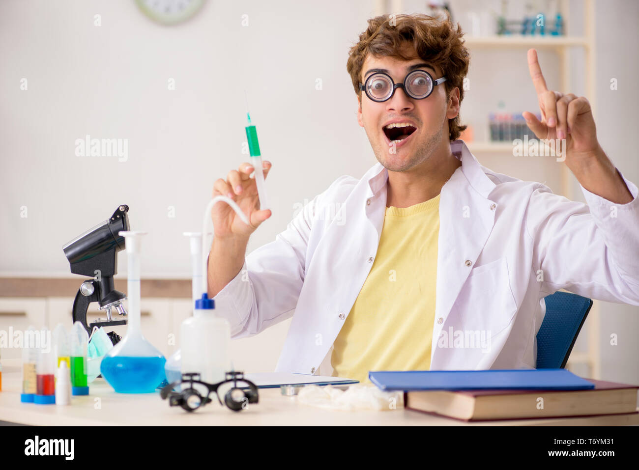 Funny crazy chemist doing experiments and tests Stock Photo