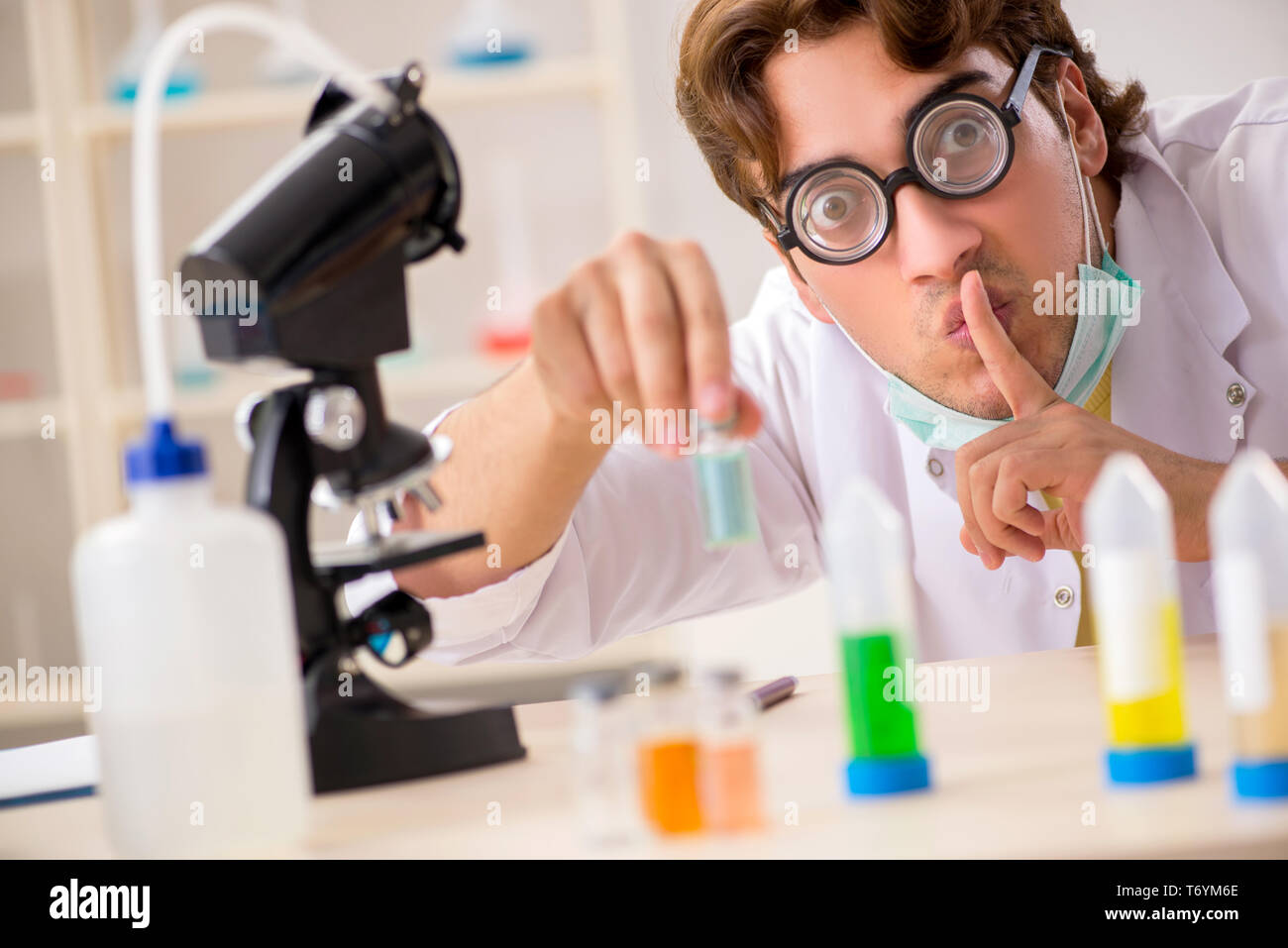 Funny crazy chemist doing experiments and tests Stock Photo