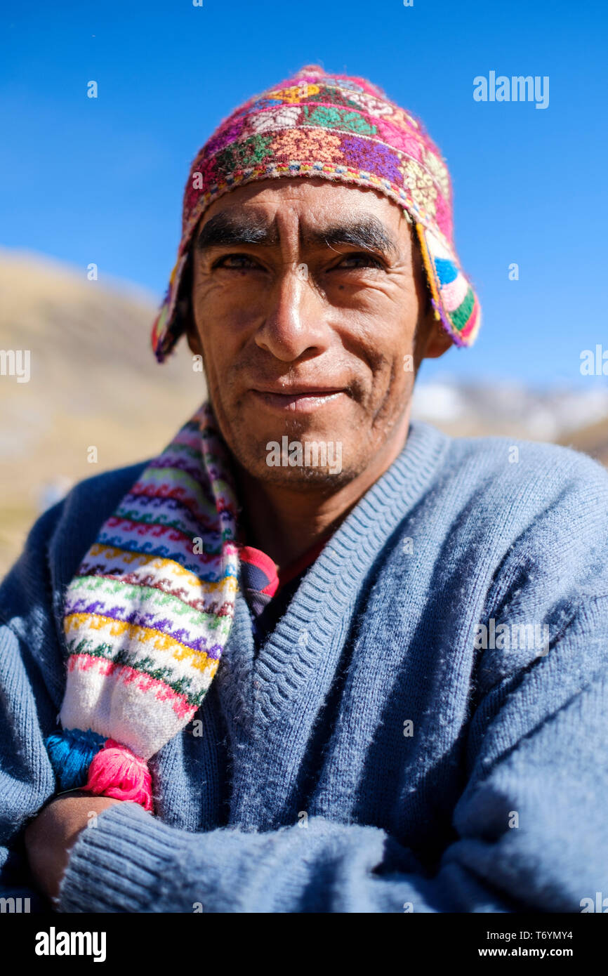 Portrait of a local Peruvian guide wearing a typical alpaca wool hat on the hike to the Rainbow Mountain, Los Andes, Peru Stock Photo