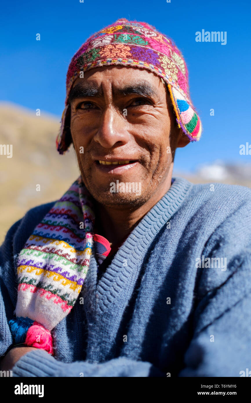 Portrait of a local Peruvian guide wearing a typical alpaca wool hat on the hike to the Rainbow Mountain, Los Andes, Peru Stock Photo