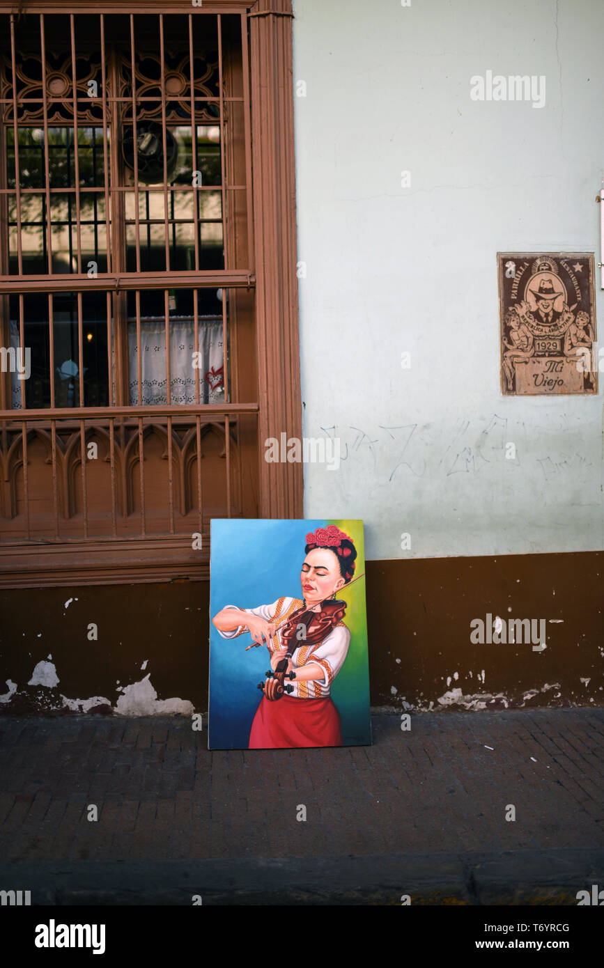 Painting of Frida Kahlo playing violin for sale in Bogota, Colombia Stock Photo