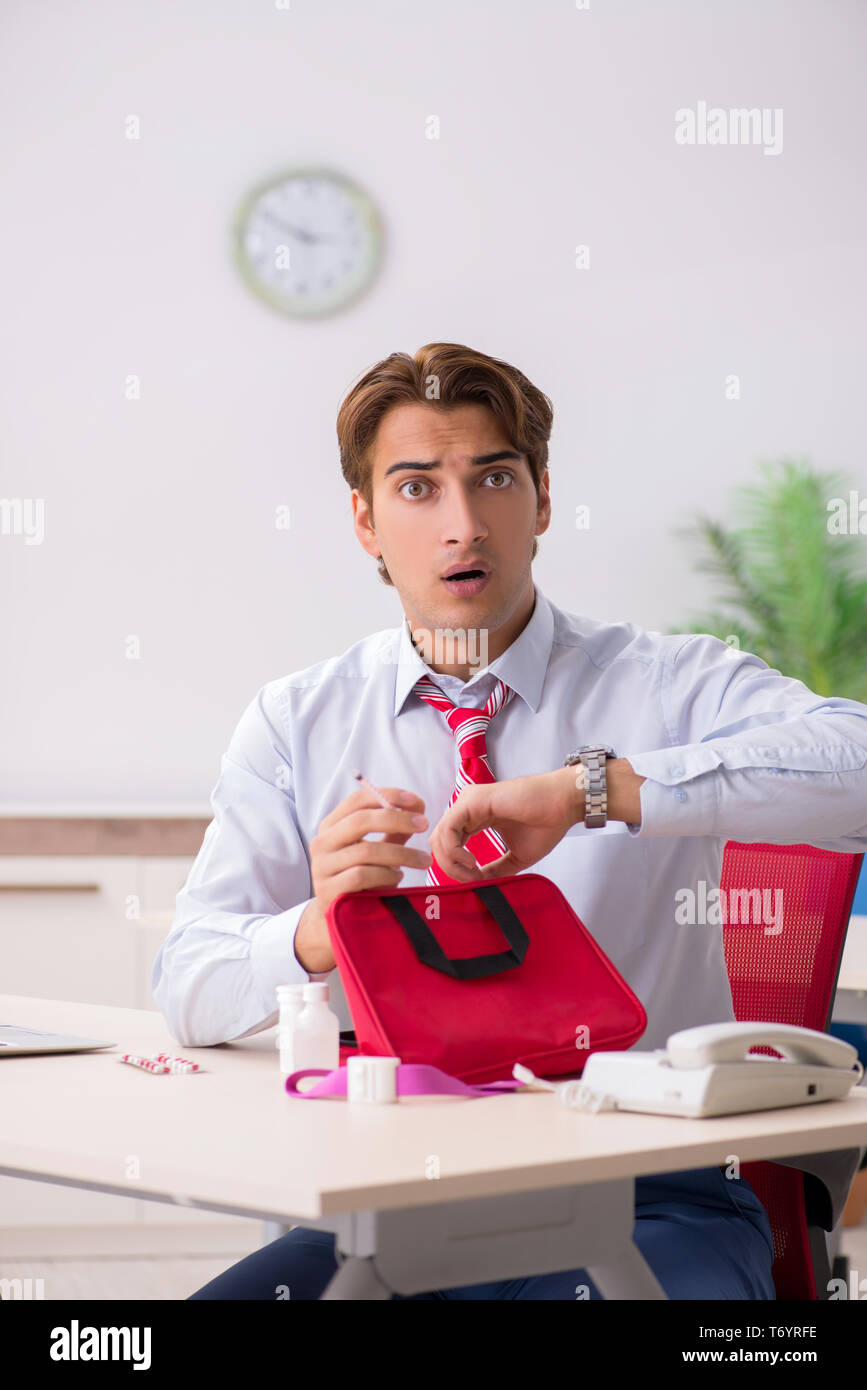 The man with first aid kit in the office Stock Photo Alamy