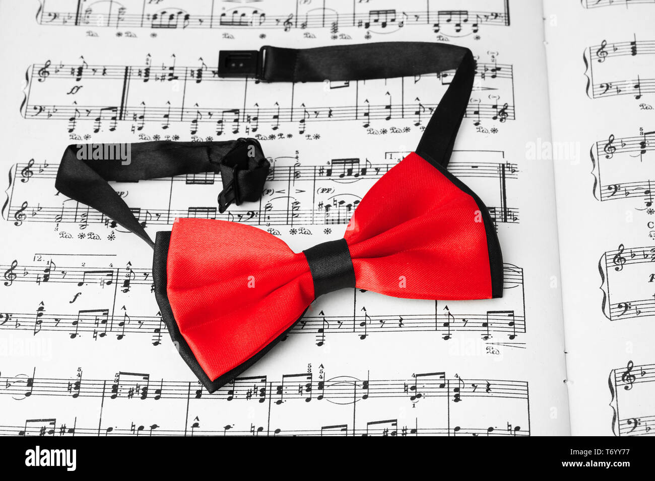 Red bow tie on music sheet Stock Photo