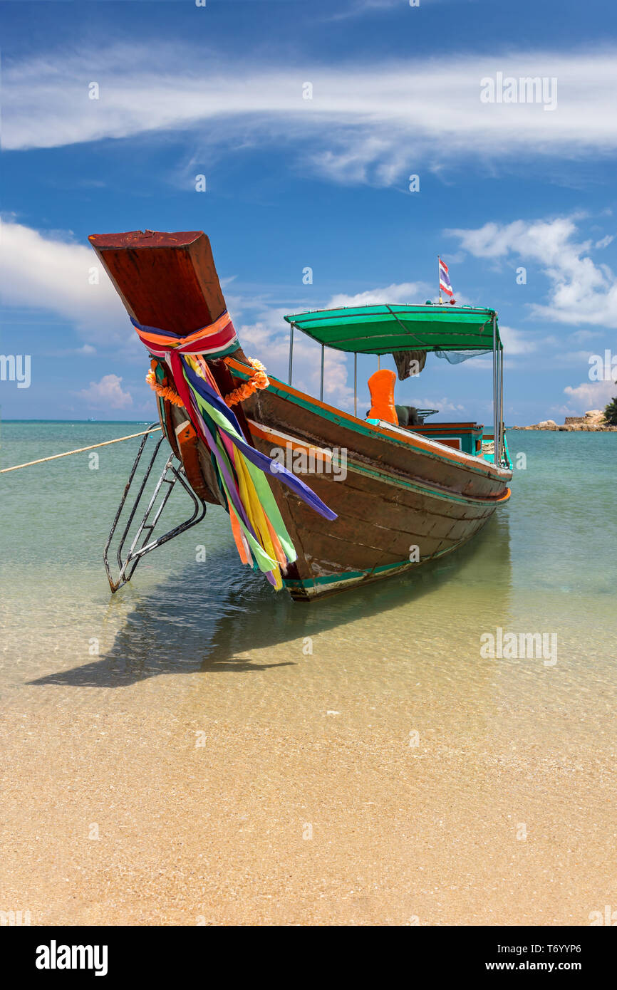 Traditional thai long boat moored at a beach Stock Photo