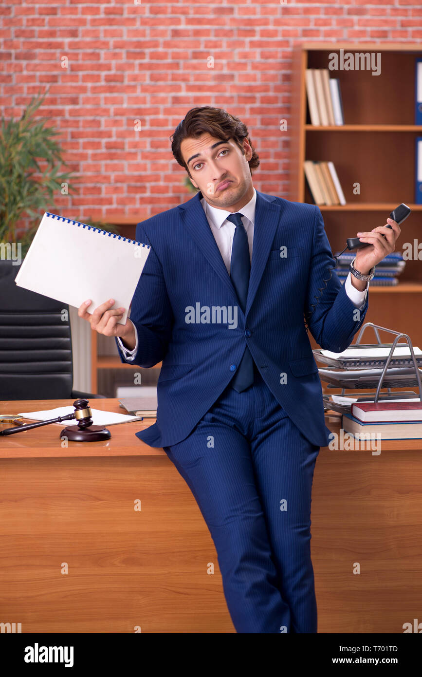 Young handsome lawyer working in his office Stock Photo