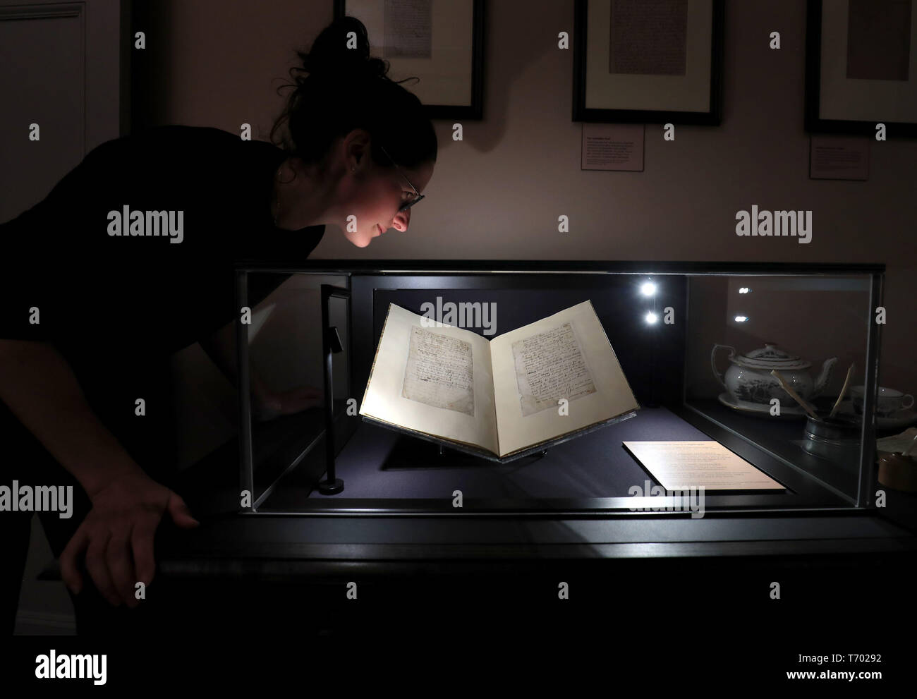 Sofie Davis, Interpretation Officer at Keats House, inspects Ode to a Nightingale, one of John Keats' most popular and acclaimed poems as it goes on display at Keats House in London, 200 years after it was written there. Stock Photo