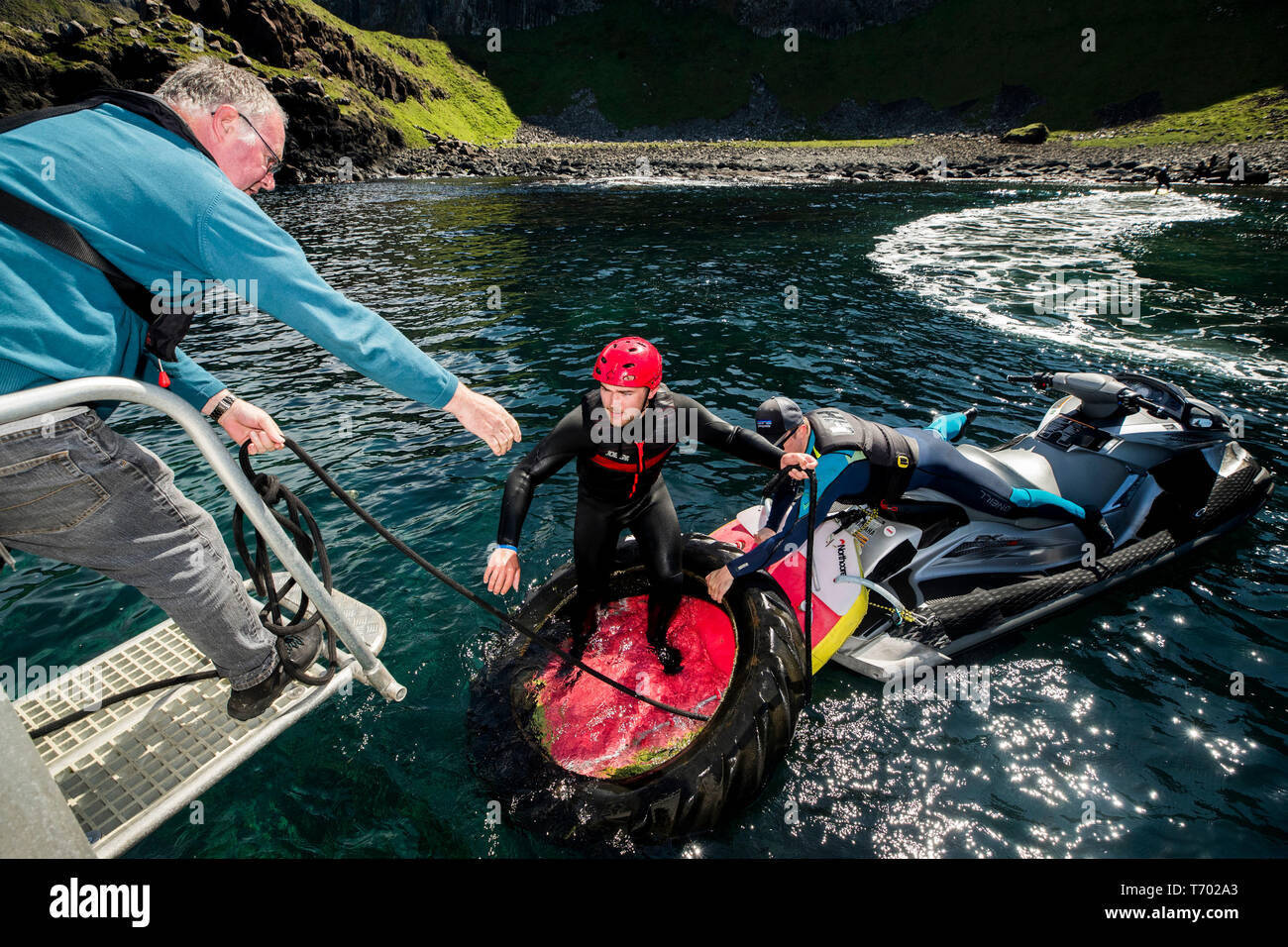 Volunteers load rubbish onto a boat during a litter pick around the