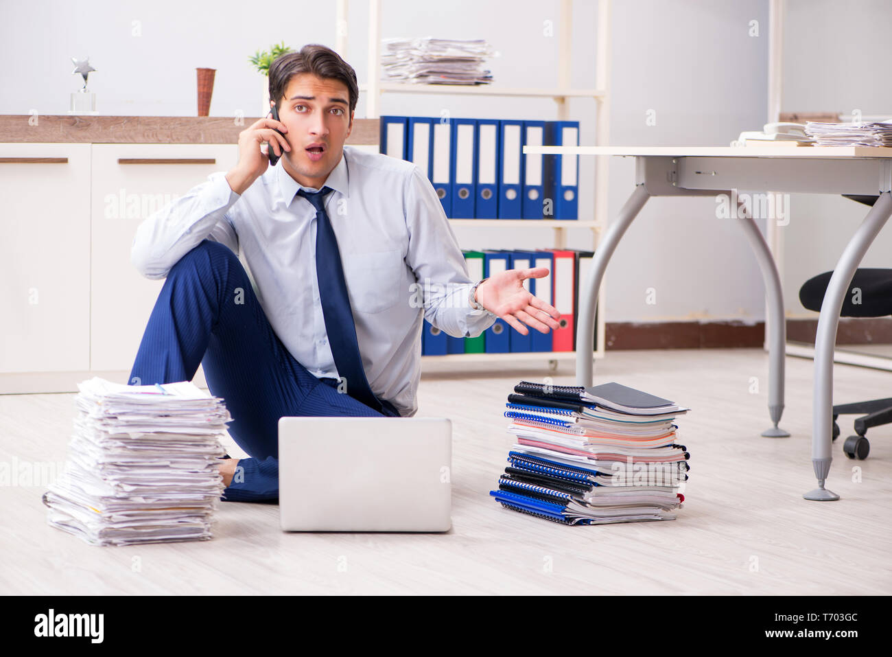 Extremely busy employee working in the office Stock Photo