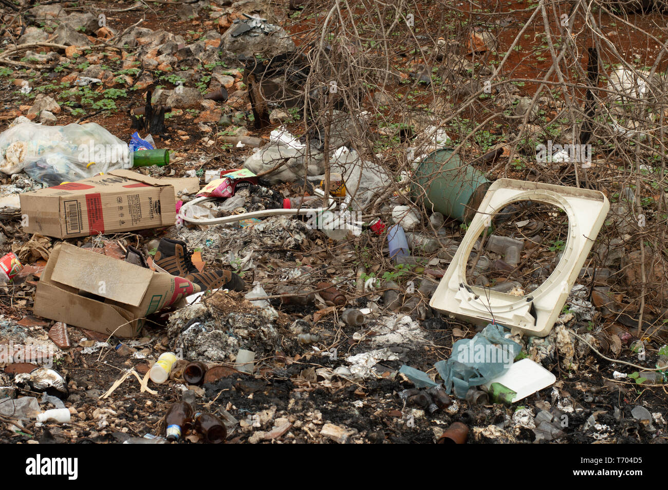 Dump on the side of the road in Yucatan, Mexico. We can see glass bottles, plastic objects and bags, and other pollutants. Stock Photo
