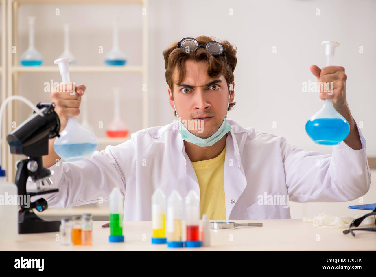 Funny crazy chemist doing experiments and tests Stock Photo