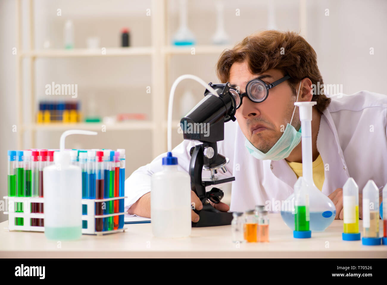 Funny crazy chemist doing experiments and tests Stock Photo