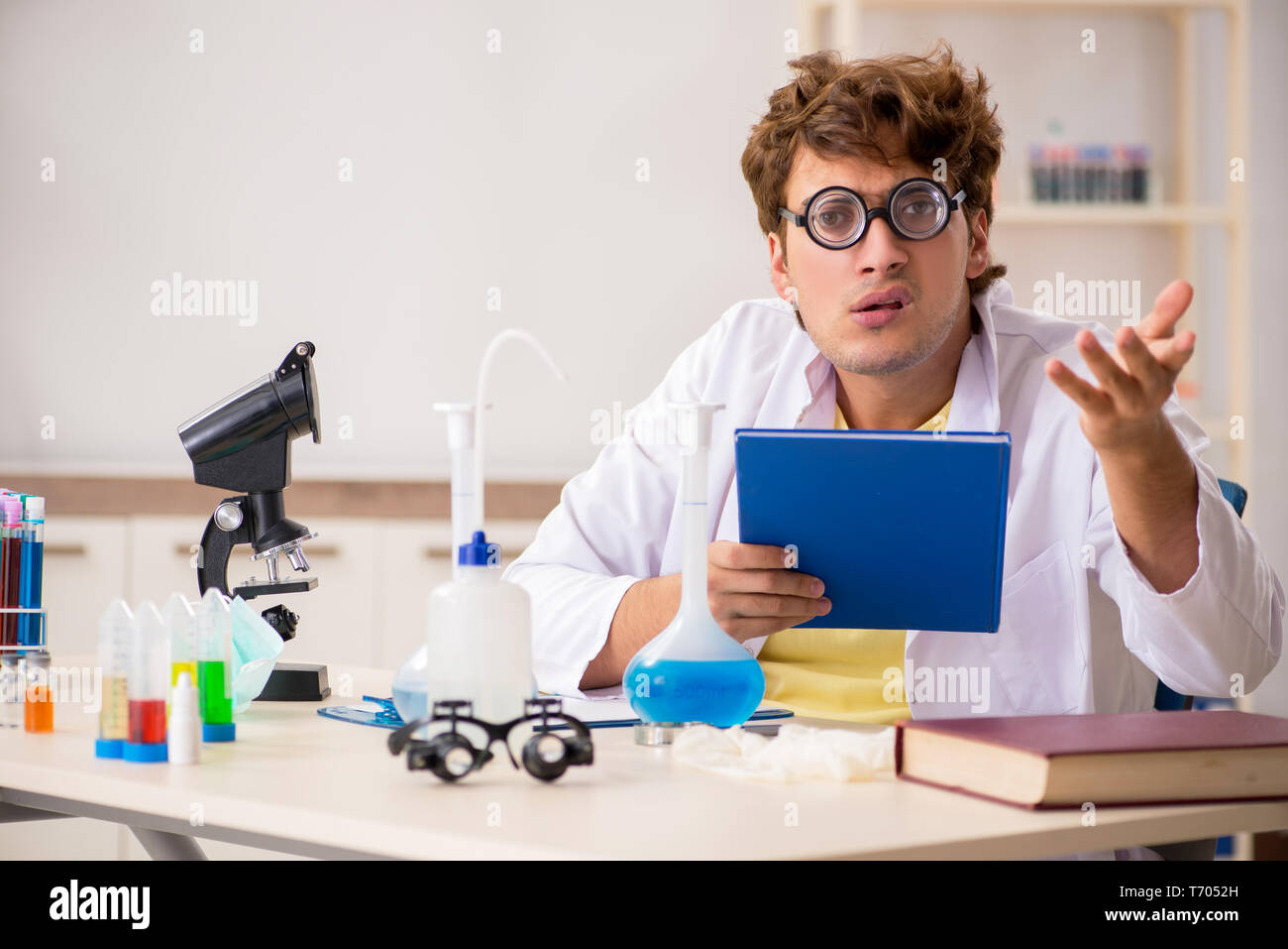 Funny crazy chemist doing experiments and tests Stock Photo