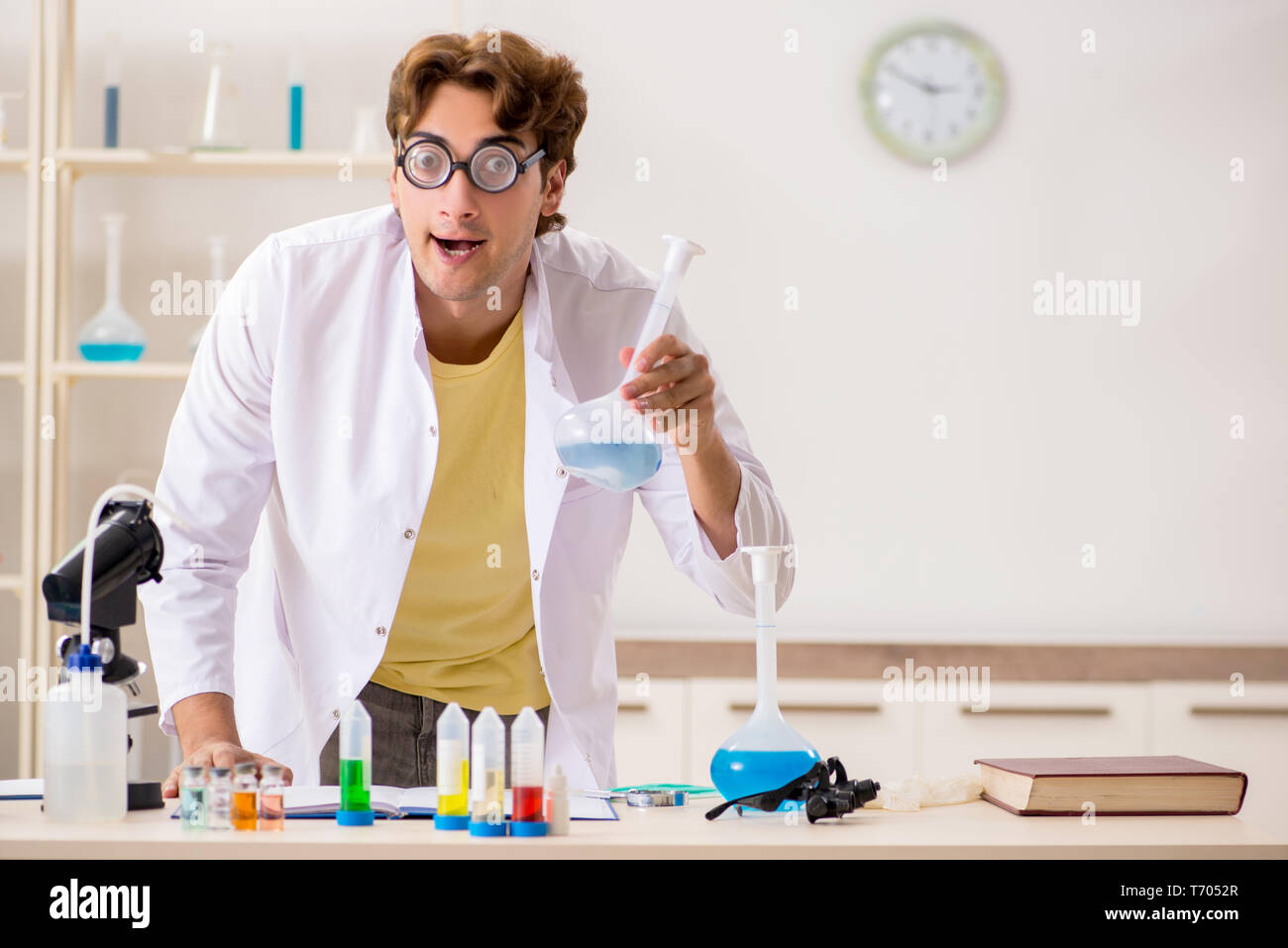 Funny crazy chemist doing experiments and tests Stock Photo