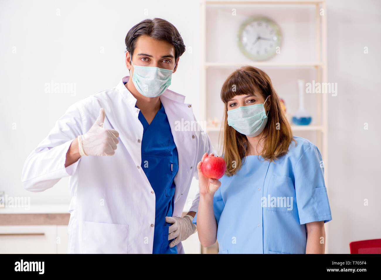 Doctor surgical mask woman apple hi-res stock photography and images ...