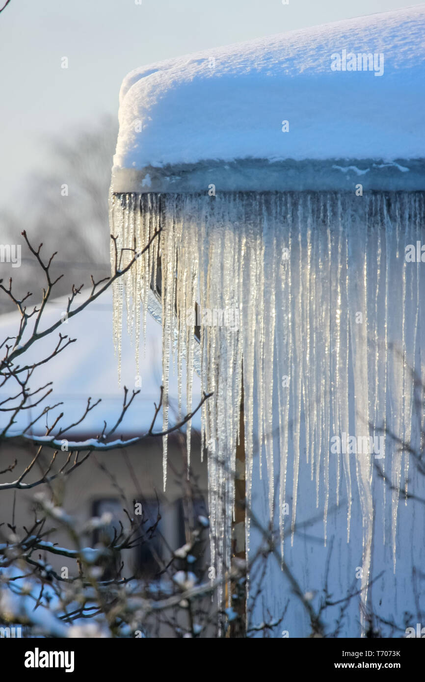 Roof with icicles hanging from roof Stock Photo Alamy