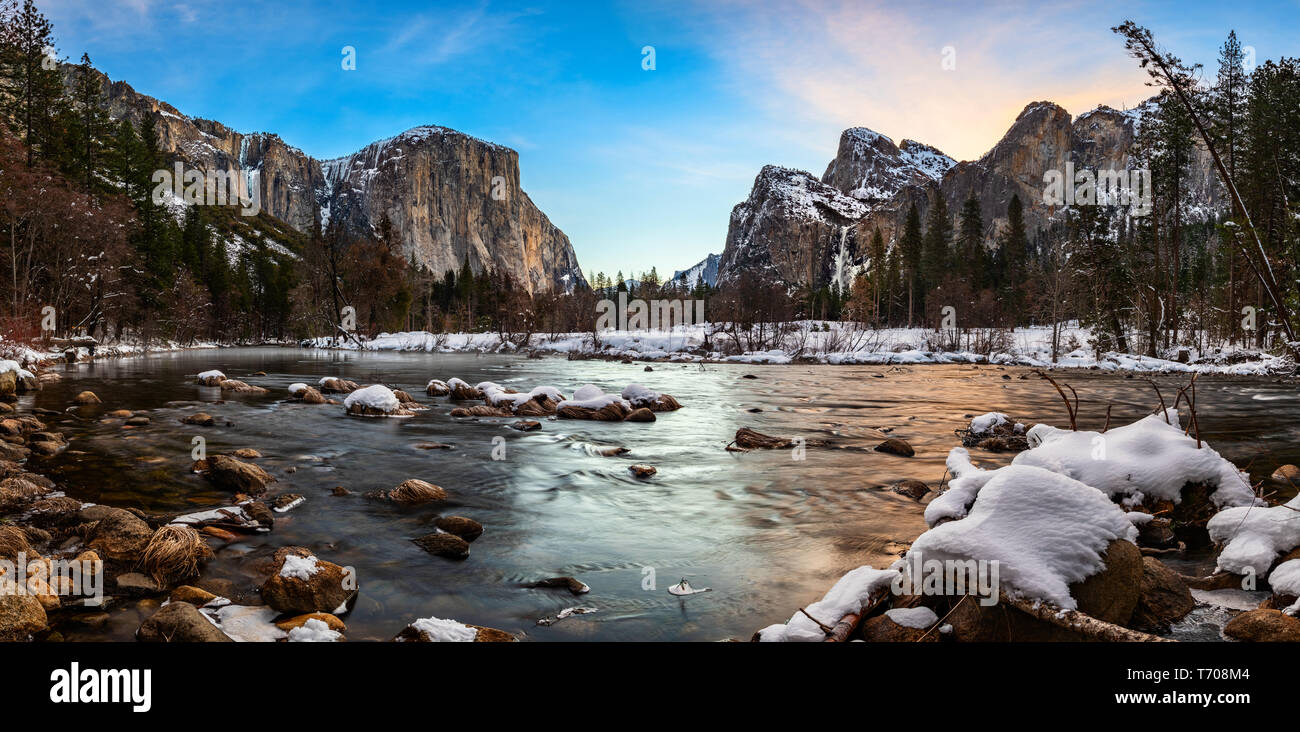 Yosemite Valley is a glacial valley in the western Sierra Nevada mountains of California's Yosemite National Park, carved out by the Merced River. The Stock Photo