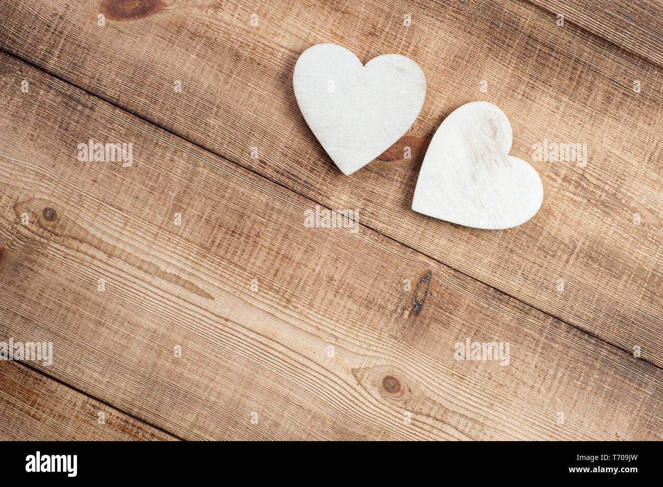 Two wood heart on a vintage wooden background. Stock Photo