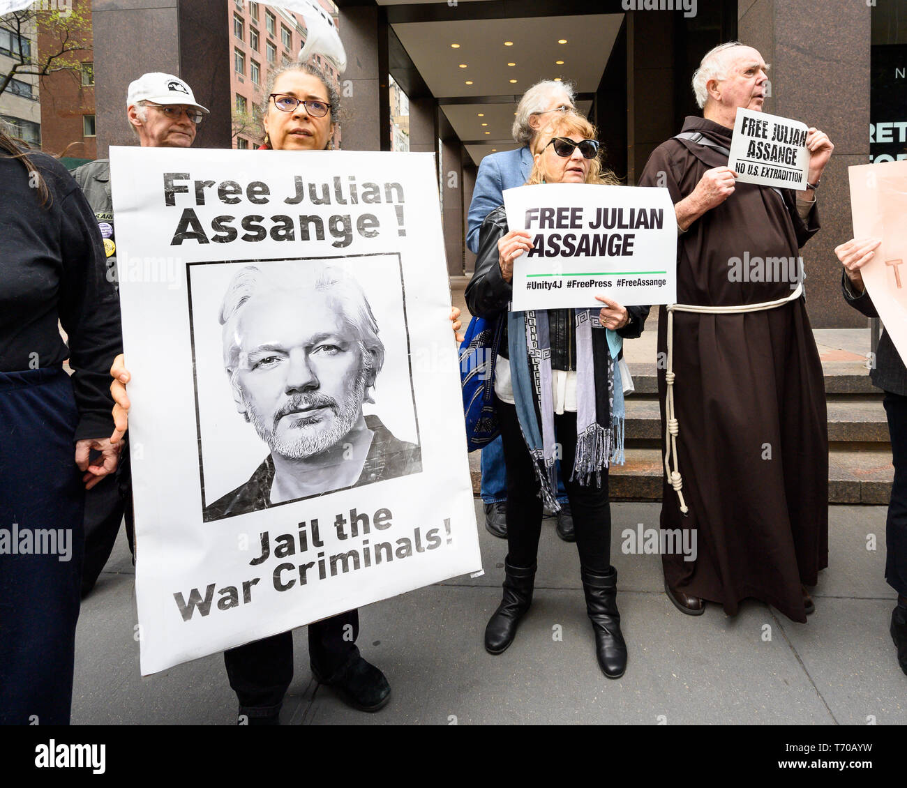 Demonstrators seen with placards during a rally in support of Julian Assange held in front of the British consulate in New York City. Stock Photo