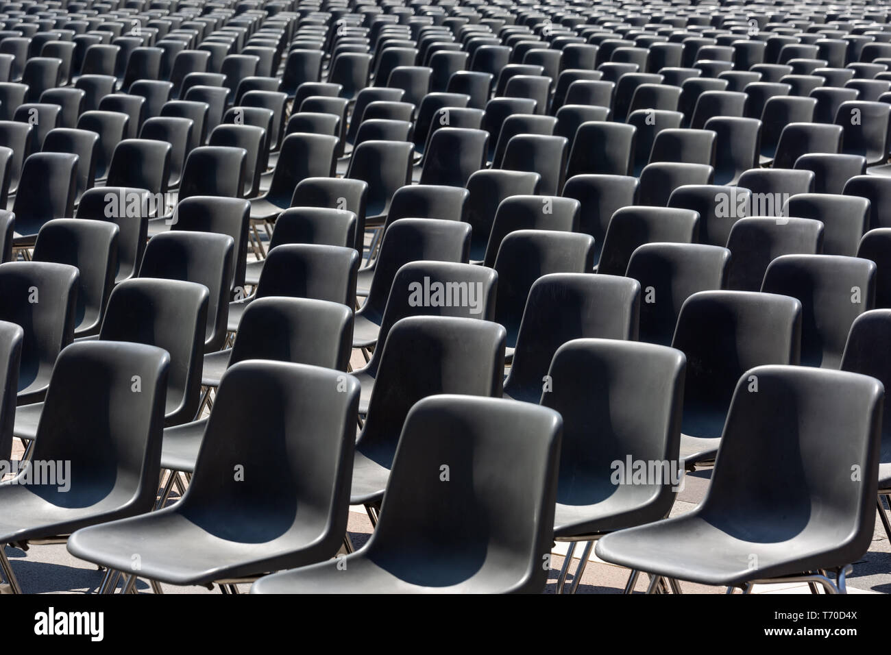 Rows of empty black plastic seats Stock Photo