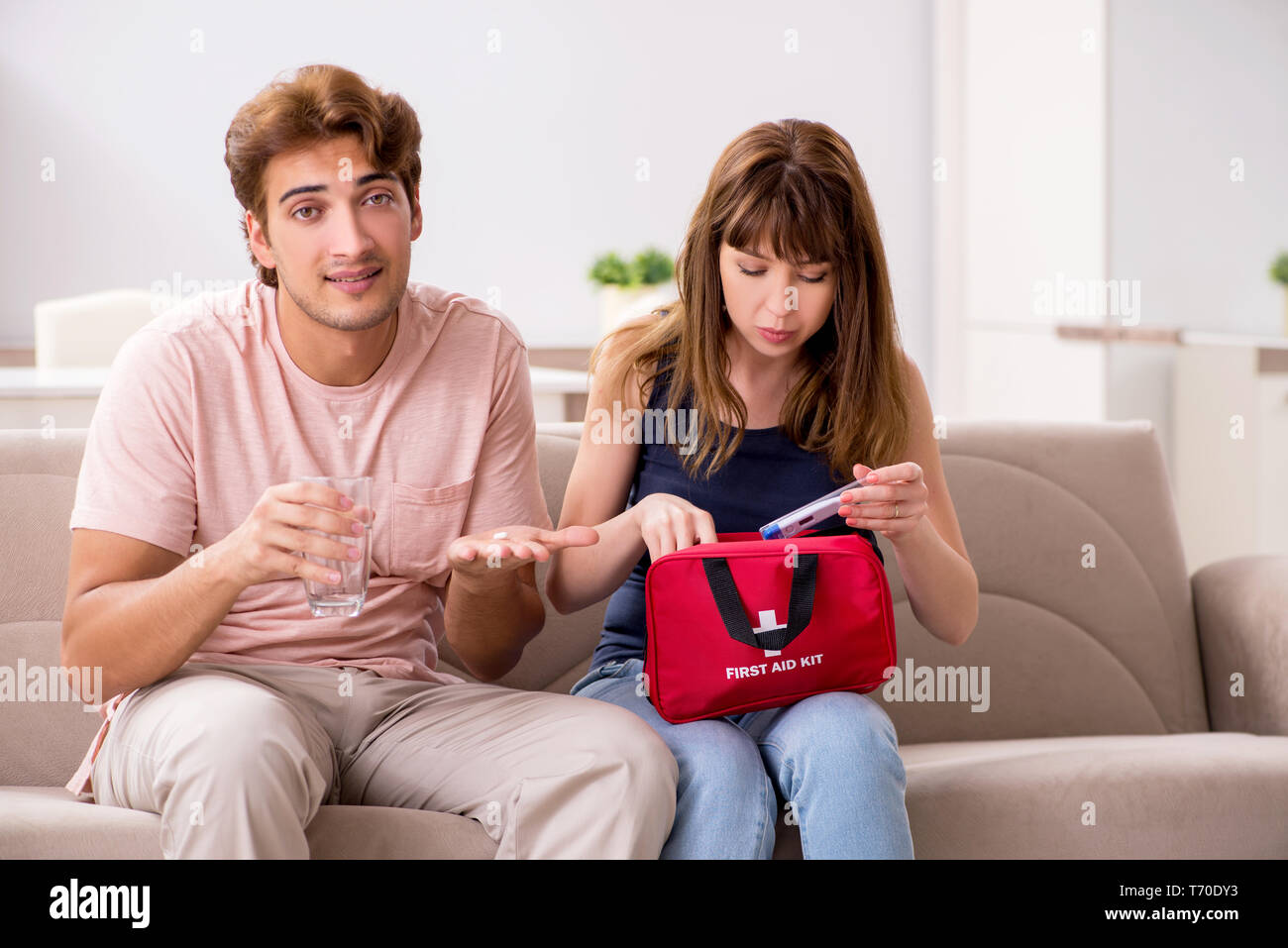 Young family getting treatment with first aid kit Stock Photo Alamy