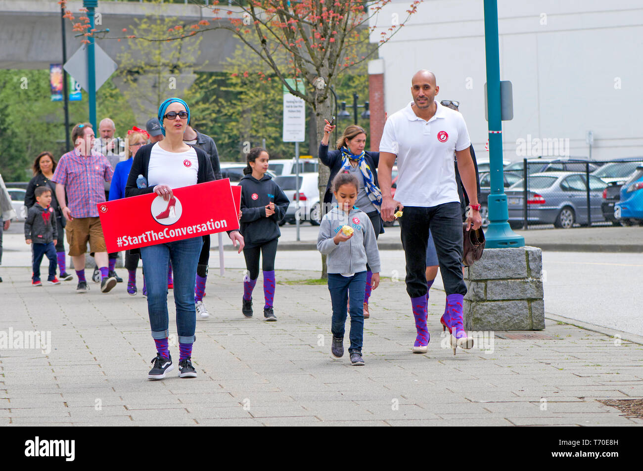A group of people walking for gender equality during a Walk a Mile in Her Shoes campaign. Stock Photo