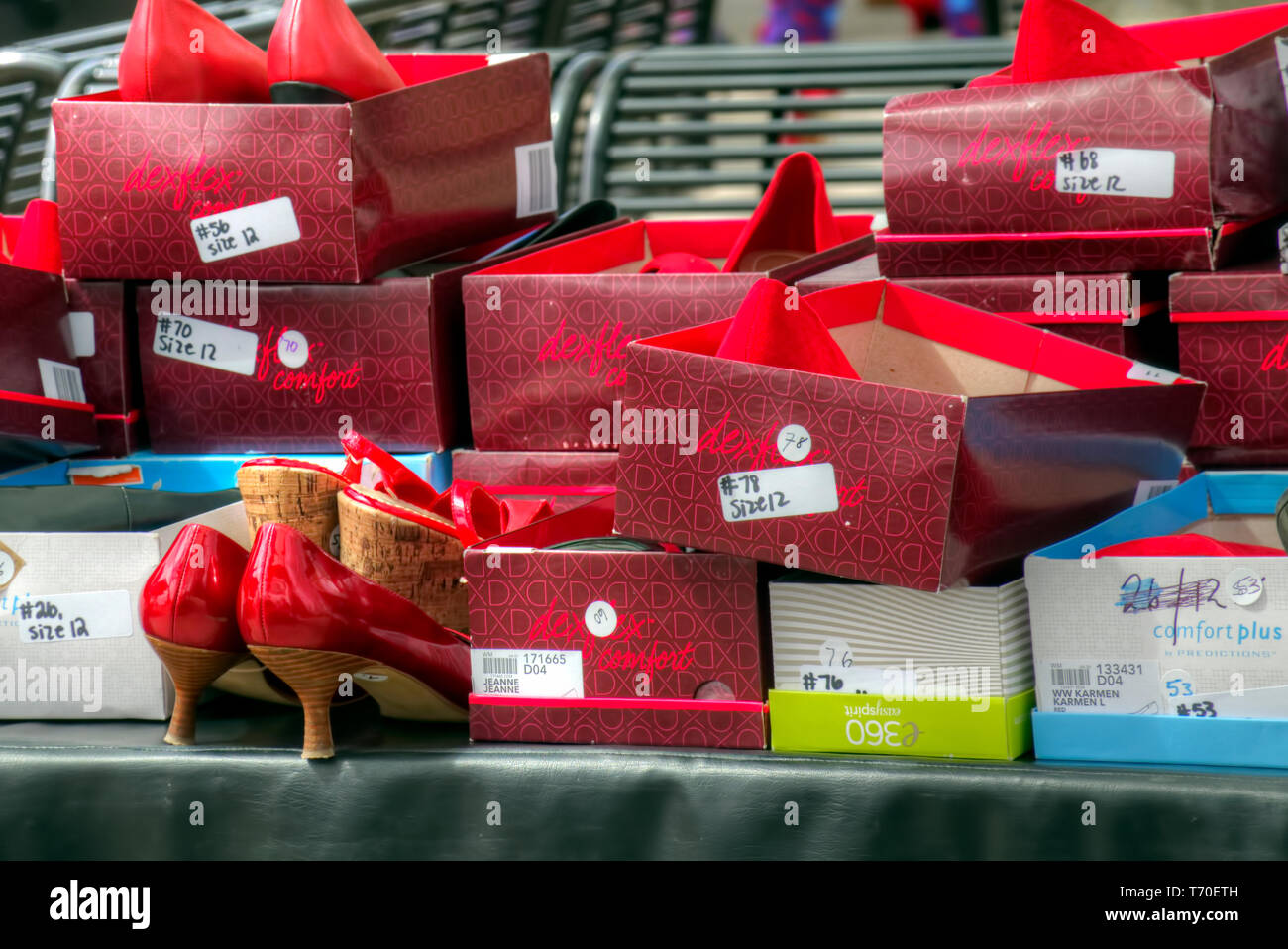 Boxes of red high heels to be worn by men supporting a Walk a Mile in Her Shoes campaign to raise awareness for gender equality. Stock Photo