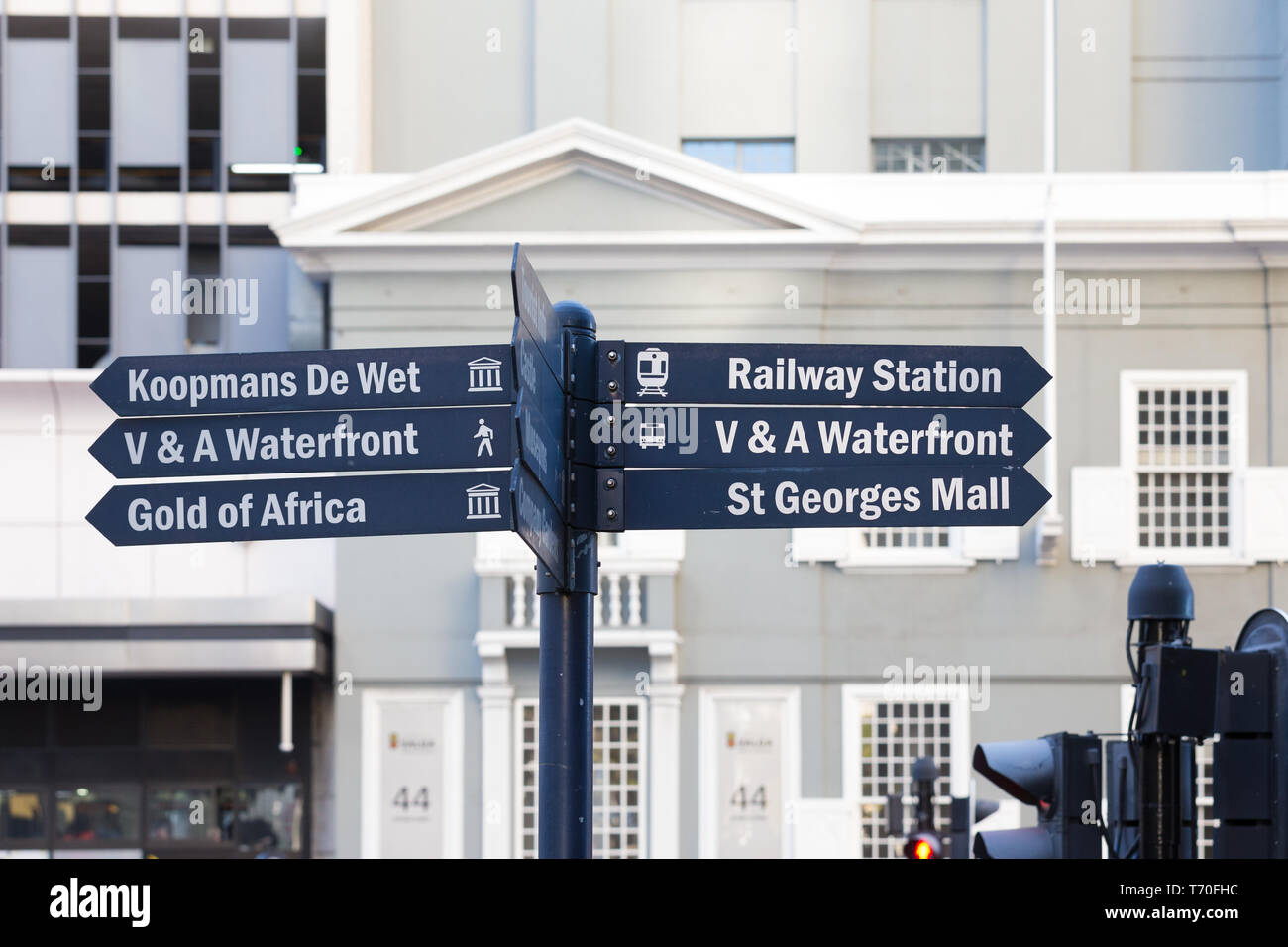 blue direction boards or arrows with names and text of tourist attractions in the city centre and surrounding area of Cape Town, South Africa Stock Photo