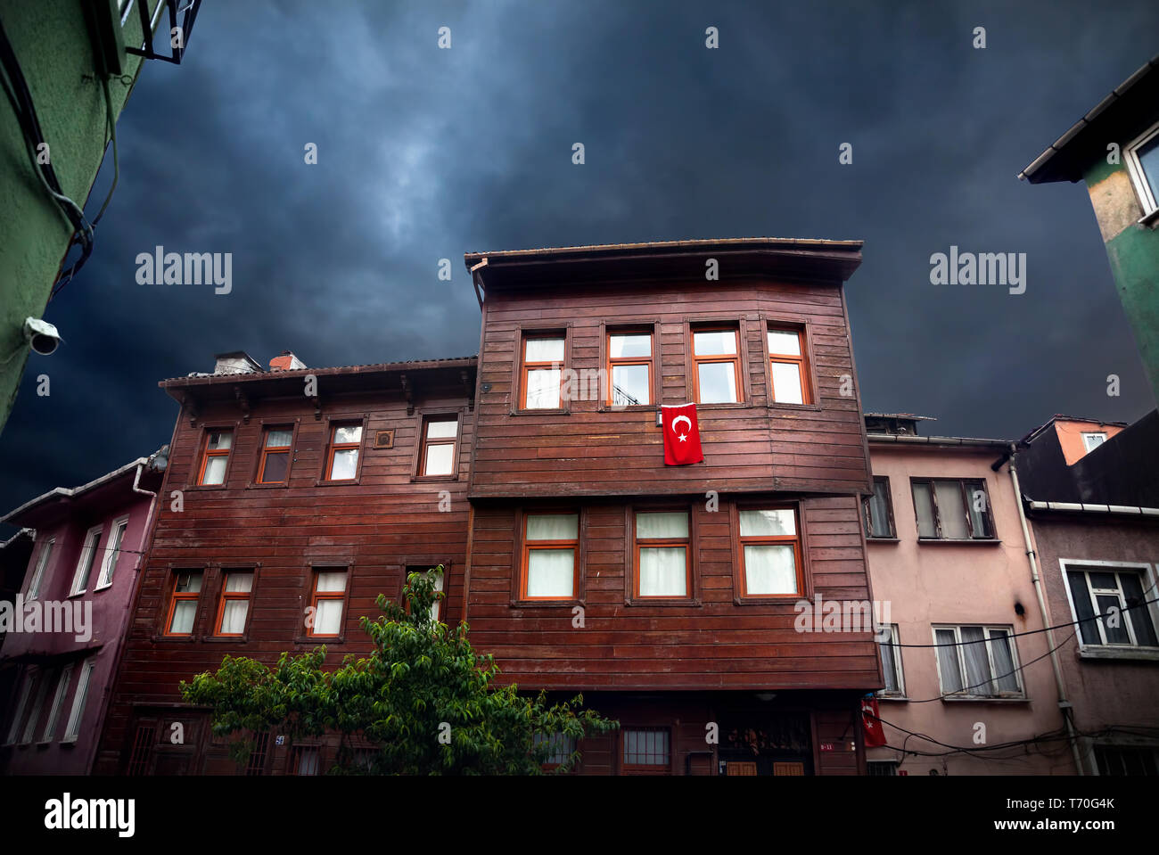 Old houses with Turkish red flag in Sultanahmet at overcast sky, Istanbul, Turkey Stock Photo